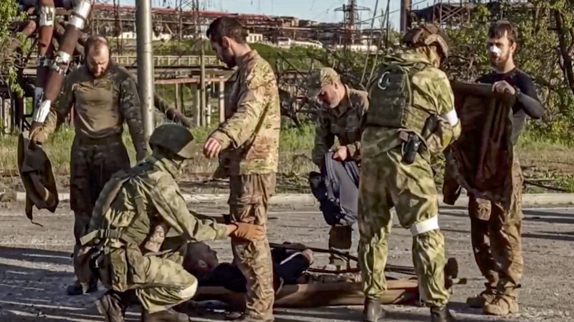 epa09952366 A handout still image taken from a handout video made available by the Russian Defence Ministry&#039;s press service shows Russian soldiers frisking Ukrainian servicemen as they are being evacuated from the besieged Azovstal steel plant in Mariupol, Ukraine, 17 May 2022. A total of 265 Ukrainian militants, including 51 seriously wounded, have laid down arms and surrendered to Russian forces, the Russian Ministry of Defence said on 17 May 2022. Those in need of medical assistance were sent for treatment to a hospital in Novoazovsk, the ministry states further. Russian President Putin on 21 April 2022 ordered his Defence Minister to not storm but to blockade the plant where a number of Ukrainian fighters were holding out. On 24 February, Russian troops invaded Ukrainian territory starting a conflict that has provoked destruction and a humanitarian crisis. According to the UNHCR, more than six million refugees have fled Ukraine, and a further 7.7 million people have been displaced internally within Ukraine since.  EPA/RUSSIAN DEFENCE MINISTRY PRESS SERVICE HANDOUT  BEST QUALITY AVAILABLE HANDOUT EDITORIAL USE ONLY/NO SALES