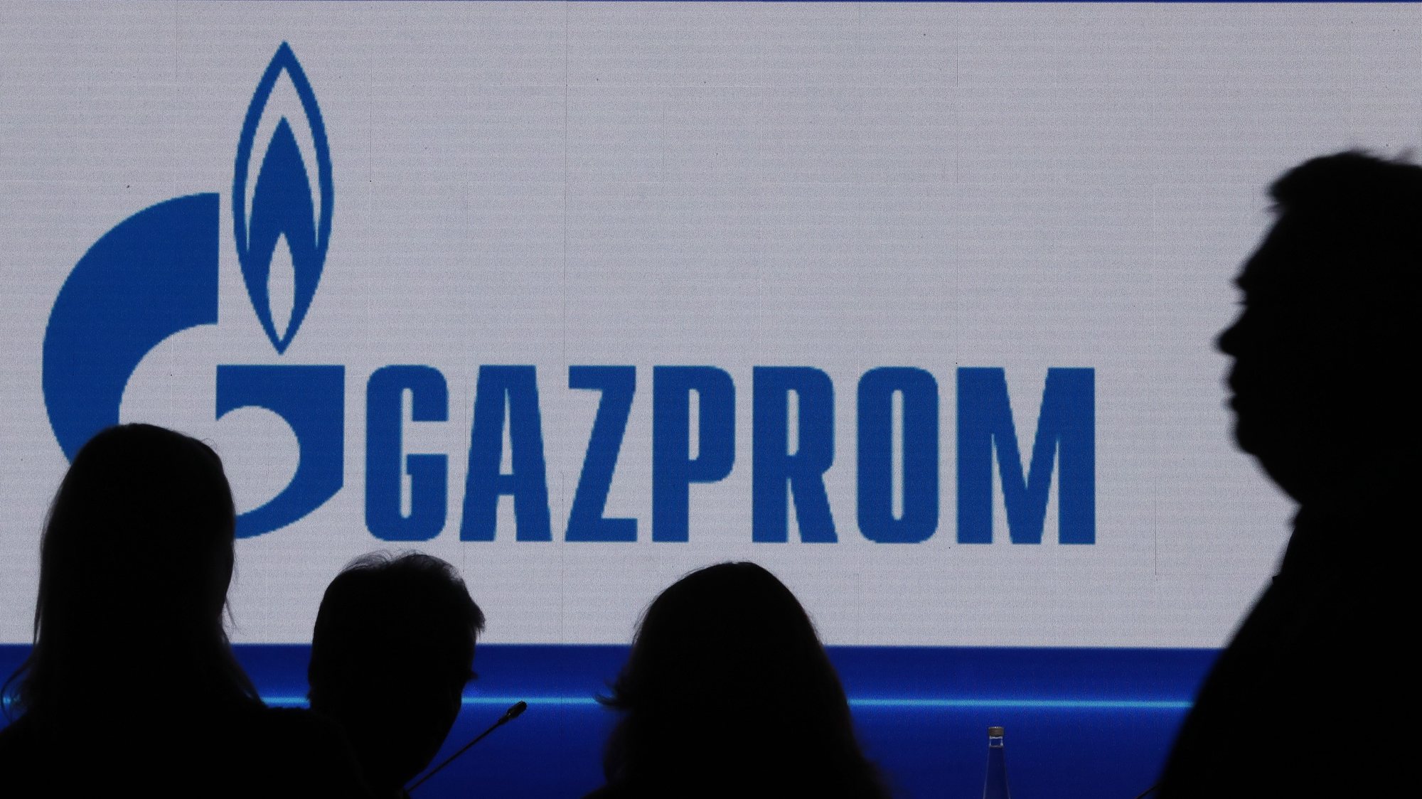 epa10185588 Participants in front of a large screen shows Gazprom Company before the plenary session â€˜Russian Gas Industry: Development Priorities in New Conditionâ€™ at the St. Petersburg International Gas Forum (SPIGF) in St. Petersburg, Russia, 15 September 2022. The 11th St.Petersburg International Gas Forum runs from 13 to 16 September 2022.  EPA/ANATOLY MALTSEV