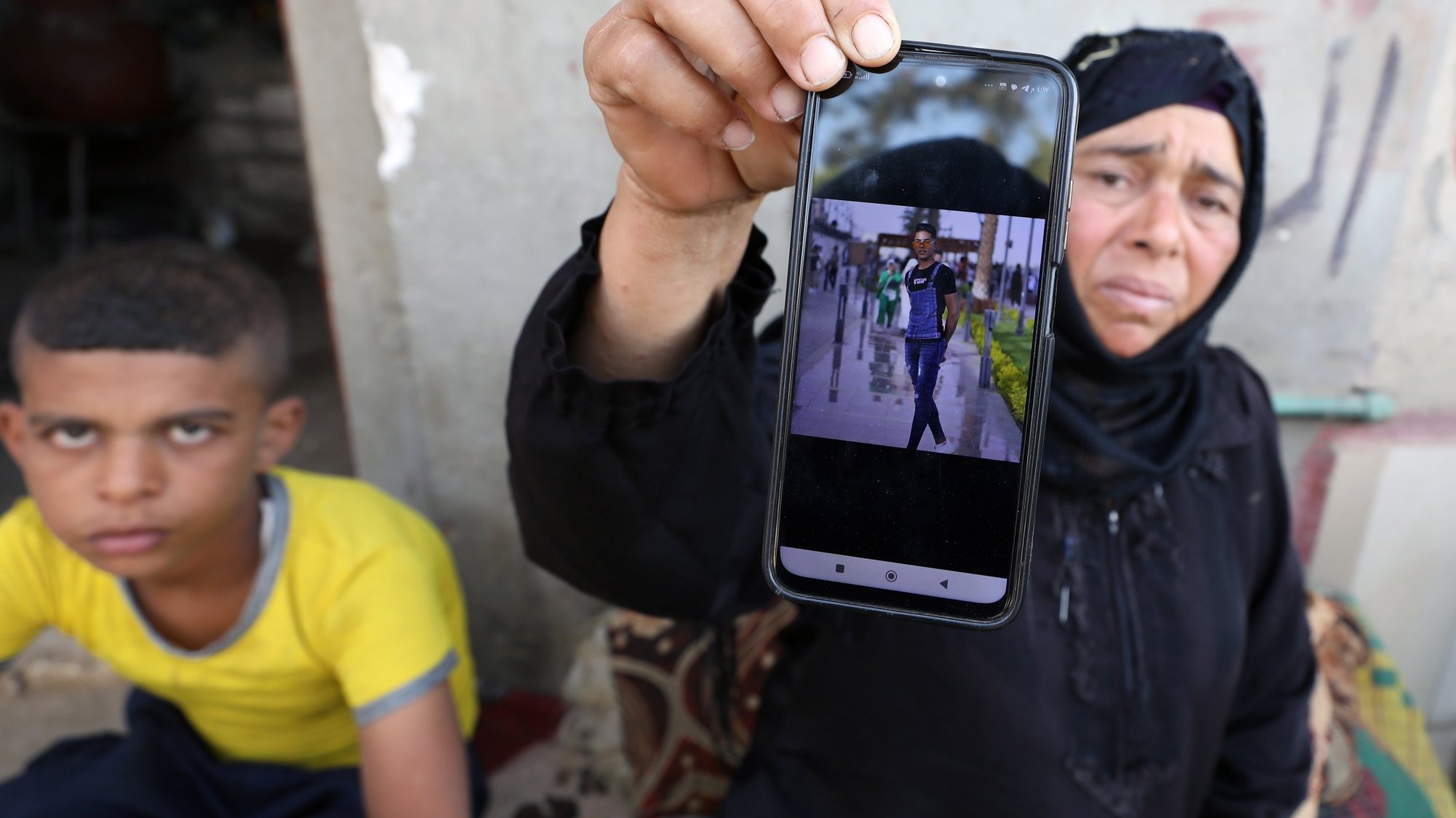 epa10858646 A relative of one of the Egyptian victims, who died in the storm that hit Libya, shows his picture at Kafr Sharif village in Beni Suef, about 120 km south of Cairo, Egypt, 13 September 2023. According to the Tobruk Medical Center, 84 Egyptians most of them from the Beni Suef governorate, died after the storm Daniel hit the Libyan coast on 11 September. Libyan authorities in the eastern part of the country estimate more than 5,000 people have died in the storm and thousands are still missing mostly in the city of Derna.  EPA/KHALED ELFIQI