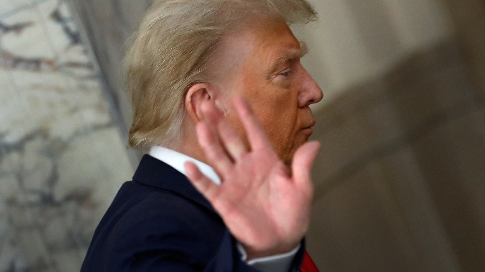 epa10998594 Former US President Donald J. Trump gestures to the media during a short recess on the third day of his civil fraud trial in New York, New York, USA, 04 October 2023.  EPA/PETER FOLEY