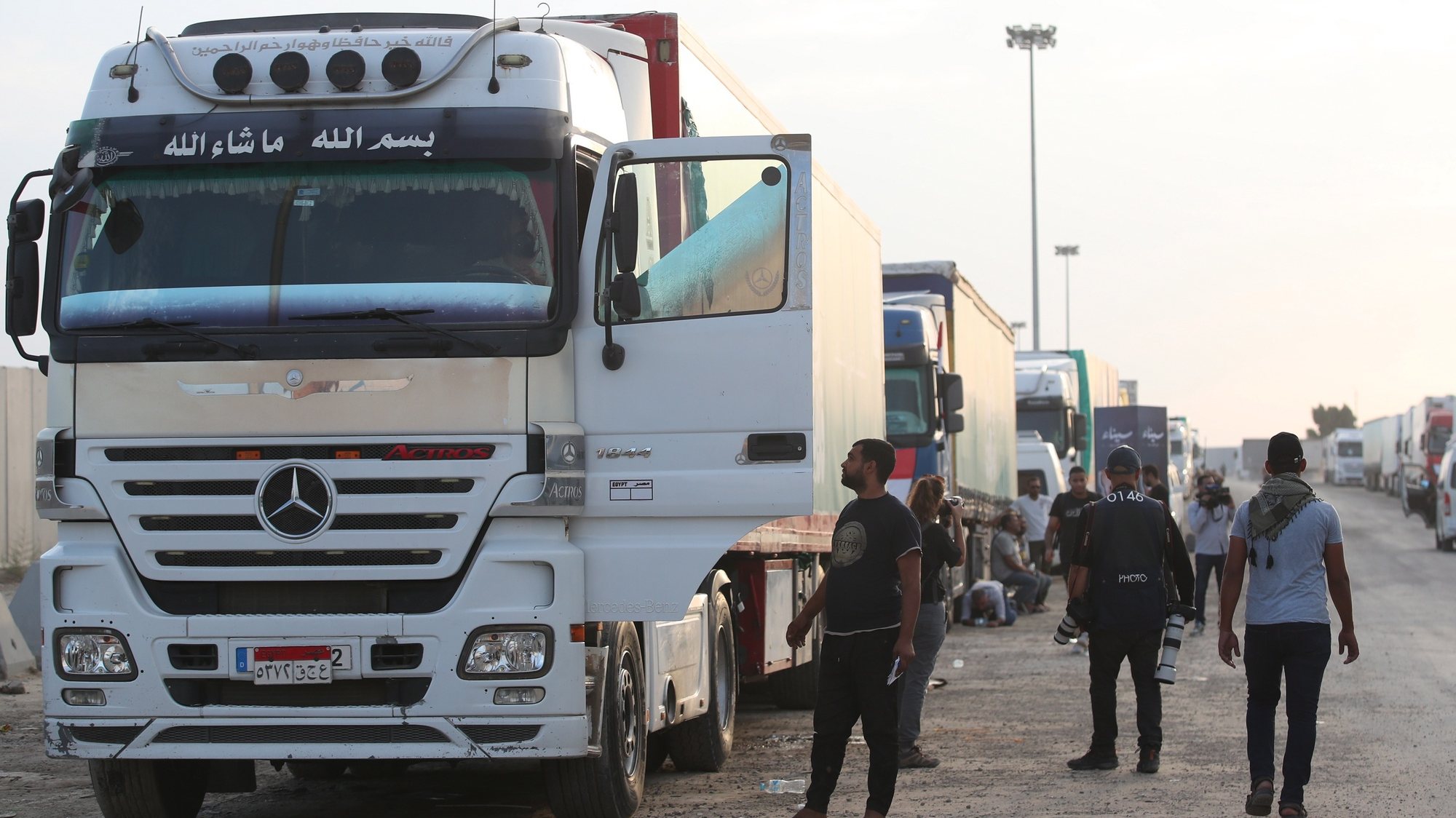 epa10951102 A humanitarian aid convoy bound for the Gaza Strip, is seen parked outside Rafah border gate, at the Rafah border crossing, Egypt, 31 October 2023. Prime Minister Mostafa Madbouly stressed Egypt will not allow any party to come close to Sinai, and will not accept the termination of any regional cause at its expense. Thousands of Israelis and Palestinians have died since the militant group Hamas launched an unprecedented attack on Israel from the Gaza Strip on 07 October, and the Israeli strikes on the Palestinian enclave which followed it.  EPA/KHALED ELFIQI