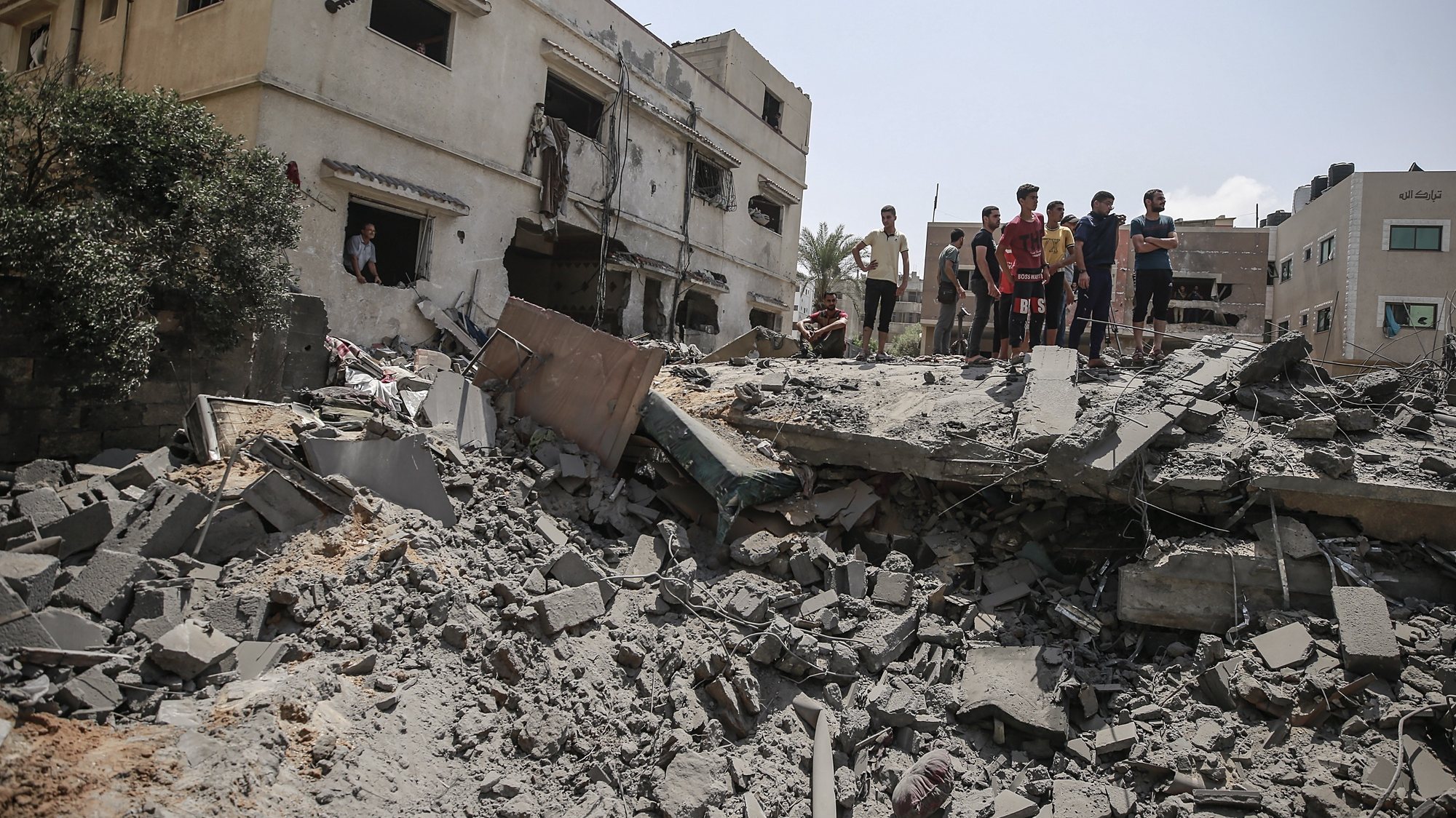 epa10108429 Palestinians inspect a destroyed house that belongs to Shamlakh family after Israeli air strikes in the south of Gaza City on, 06 August 2022. According to the Palestinian ministry of health, at least 10 people were killed, including a child, in a series of Israeli airstrikes on multiple targets in the Gaza Strip including a residential apartment in neighborhood of Al-Rimal. Al-Quds Brigades, the armed wing of the Palestinian Islamic Jihad, announced that senior leader Tayseer al-Jabari was killed in the attacks.  EPA/MOHAMMED SABER