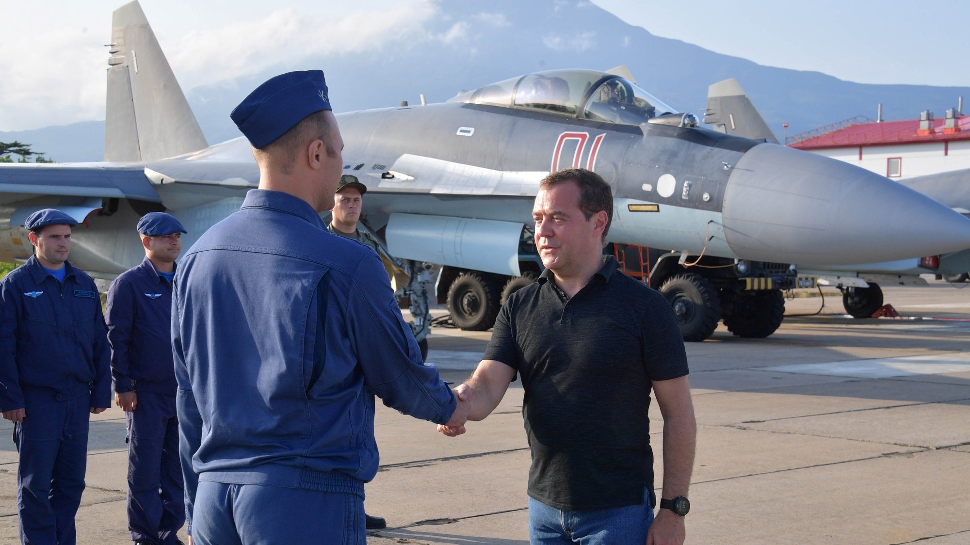 epa07753609 Russian Prime Minister Dmitry Medvedev (R) shakes hands with an air force officer at the Yasny airport on the Iturup island, the largest and northernmost island in Russia&#039;s southern Kurils, Russia, 02 August 2019.  EPA/ALEXANDER ASTAFYEV / GOVERNMENTAL PRESS SERVICE / POOL MANDATORY CREDIT/SPUTNIK
