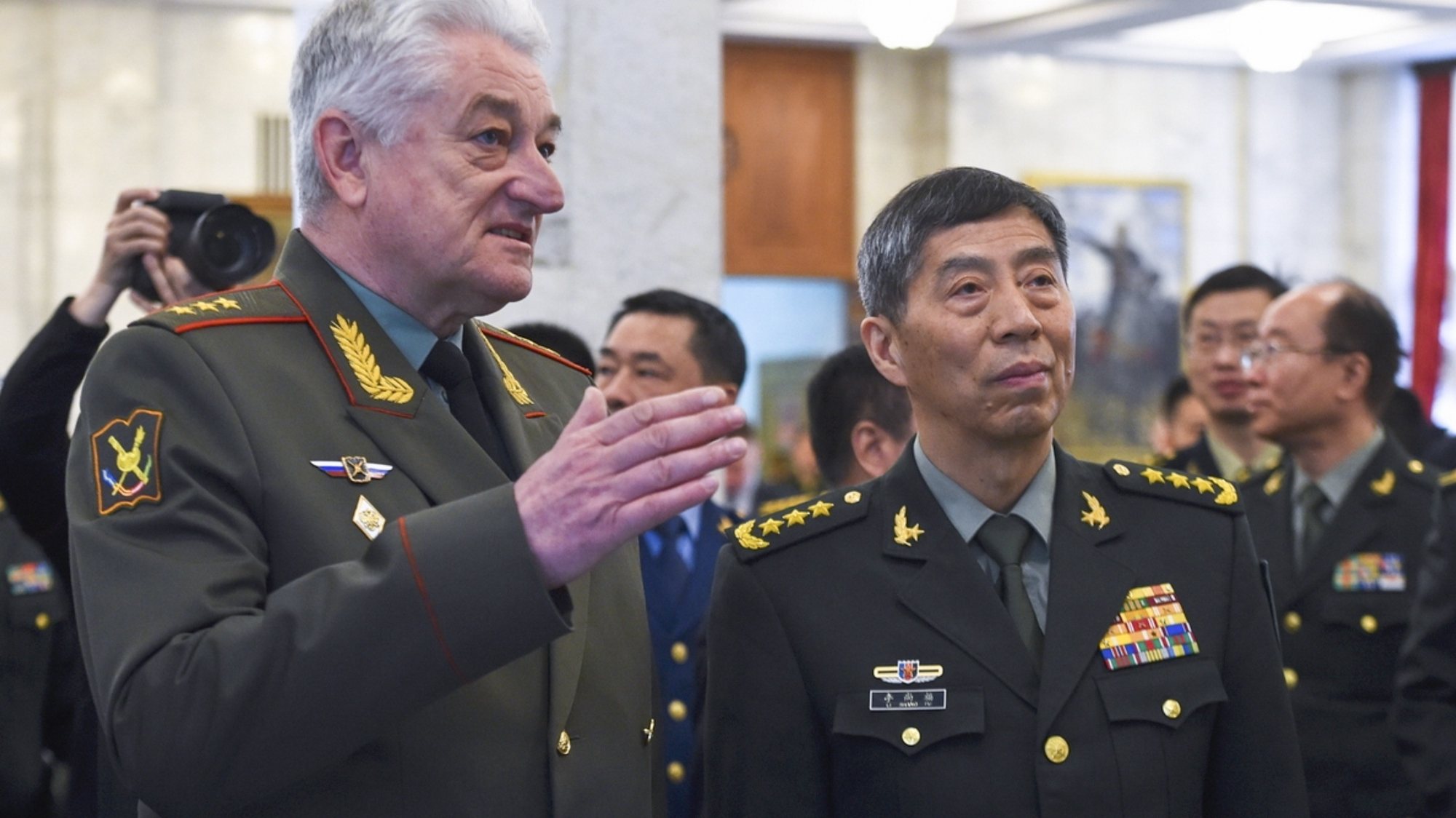 epa10576753 A handout photo made available by the Russian Defence Ministry press-service shows the Head of the Military Academy of the General Staff of the Armed Forces of the Russian Federation, Colonel General Vladimir Zarudnitsky (L) welcoming Chinese Defence Minister Gen. Li Shangfu (C) during a visit to the Military Academy of the General Staff of the Russian Armed Forces in Moscow, Russia, 17 April 2023. Chinese Defence Minister and State Councilor Gen. Li Shangfu is in Russia on an official visit.  EPA/RUSSIAN DEFENCE MINISTRY PRESS SERVICE HANDOUT -- MANDATORY CREDIT -- HANDOUT EDITORIAL USE ONLY/NO SALES