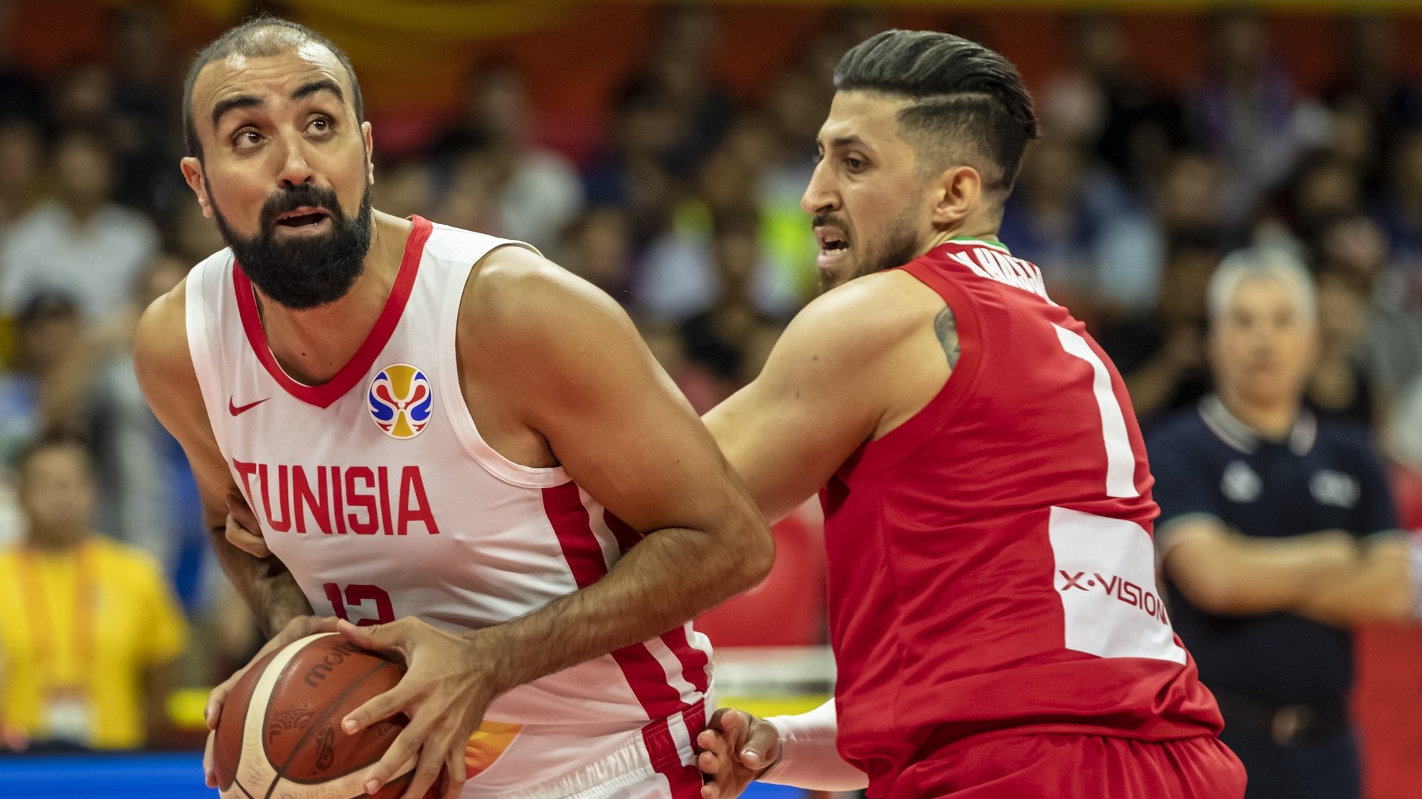 epa07812130 Makram Ben Romdhane of Tunisia (L) in action against Mohammad Hassanzadeh of Iran (R) during the FIBA Basketball World Cup 2019 match between Tunisia and Iran in Guangzhou, China, 02 September 2019.  EPA/ALEX PLAVEVSKI