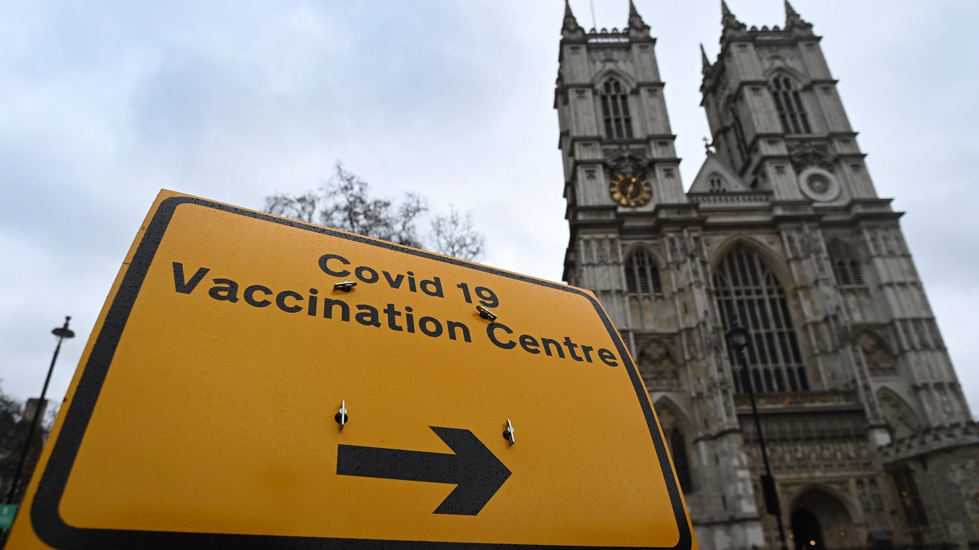 epa09065497 A Covid-19 vaccination centre sign outside Westminster Abbey in London, Britain, 10 March 2021. Westminster Abbey has opened its doors acting as a vaccination centre in London. More than twenty million people have already received their first dose of a Covid-19 vaccine in the UK.  EPA/ANDY RAIN