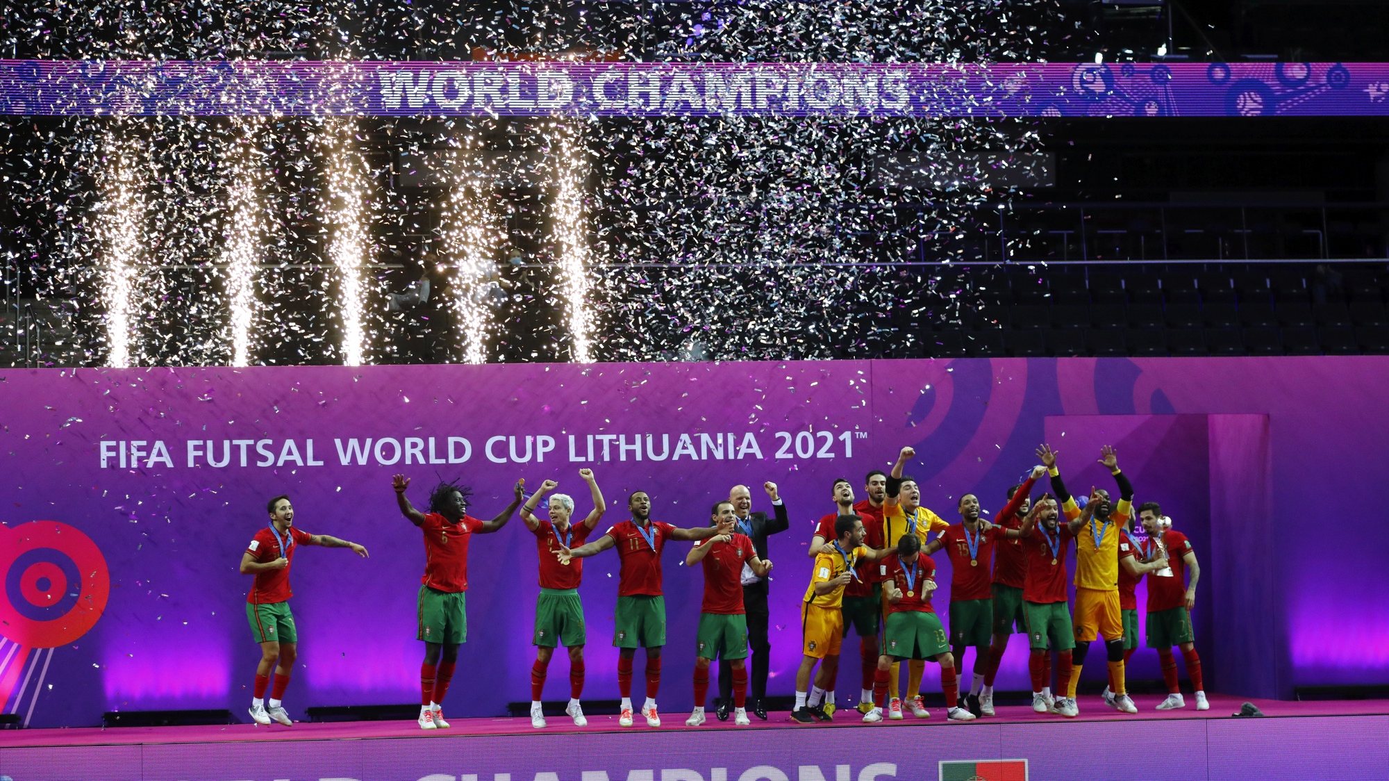 epa09504591 Players of Portugal celebrate during the award ceremony after winning the FIFA Futsal World Cup Lithuania 2021 final between Argentina and Portugal in Kaunas, Lithuania, 03 October 2021.  EPA/TOMS KALNINS