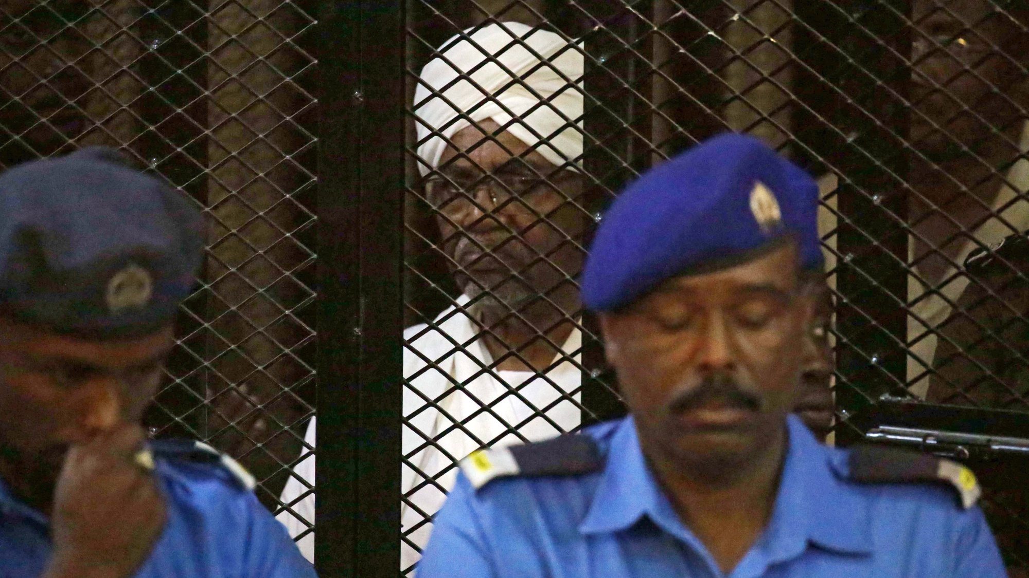 epa08211253 (FILE) - Sudan&#039;s ousted president Omar Hassan al-Bashir sits in the defendant&#039;s cage during his trial in Khartoum, Sudan, 14 December 2019 (reissued 11 February 2020). According to reports on 11 February 2020, Sudanese authorities will hand ousted president Omar al-Bashir to the International Criminal Court (ICC), where he will be facing charges of war crimes and crimes against humanity related to the war in the Darfur region.  EPA/MORWAN ALI *** Local Caption *** 55708364