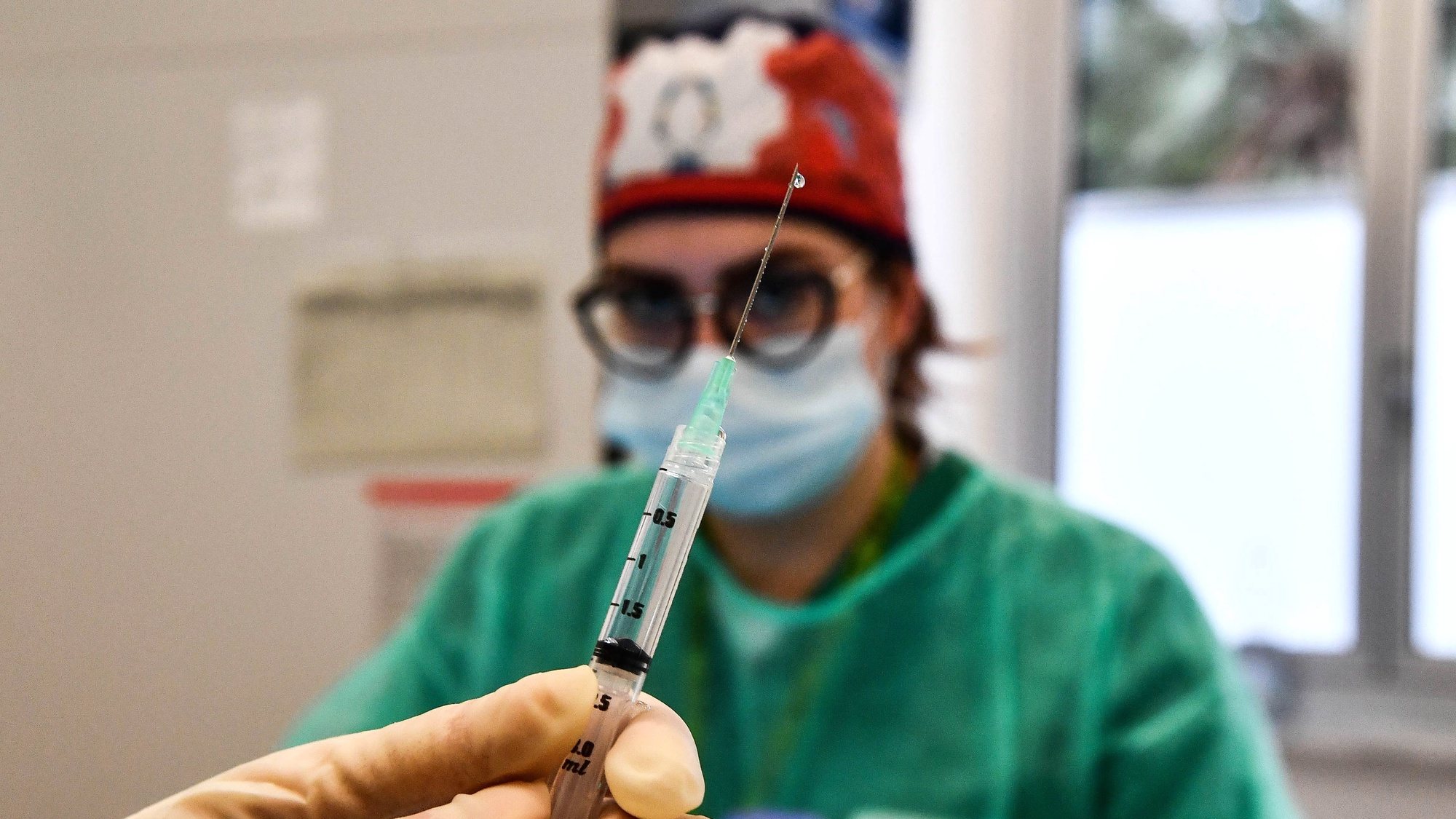 epa08920745 A healthcare worker prepares a syringe with a dose of the Pfizer-BioNTech vaccine at the Villa Scassi Hospital in Genoa, Italy, 05 January 2021. A second batch of 470,000 doses of the Pfizer-BioNTech COVID-19 vaccine reportedly has arrived in Italy and more than 100,000 people have been vaccinated with it so far in Italy.  EPA/LUCA ZENNARO