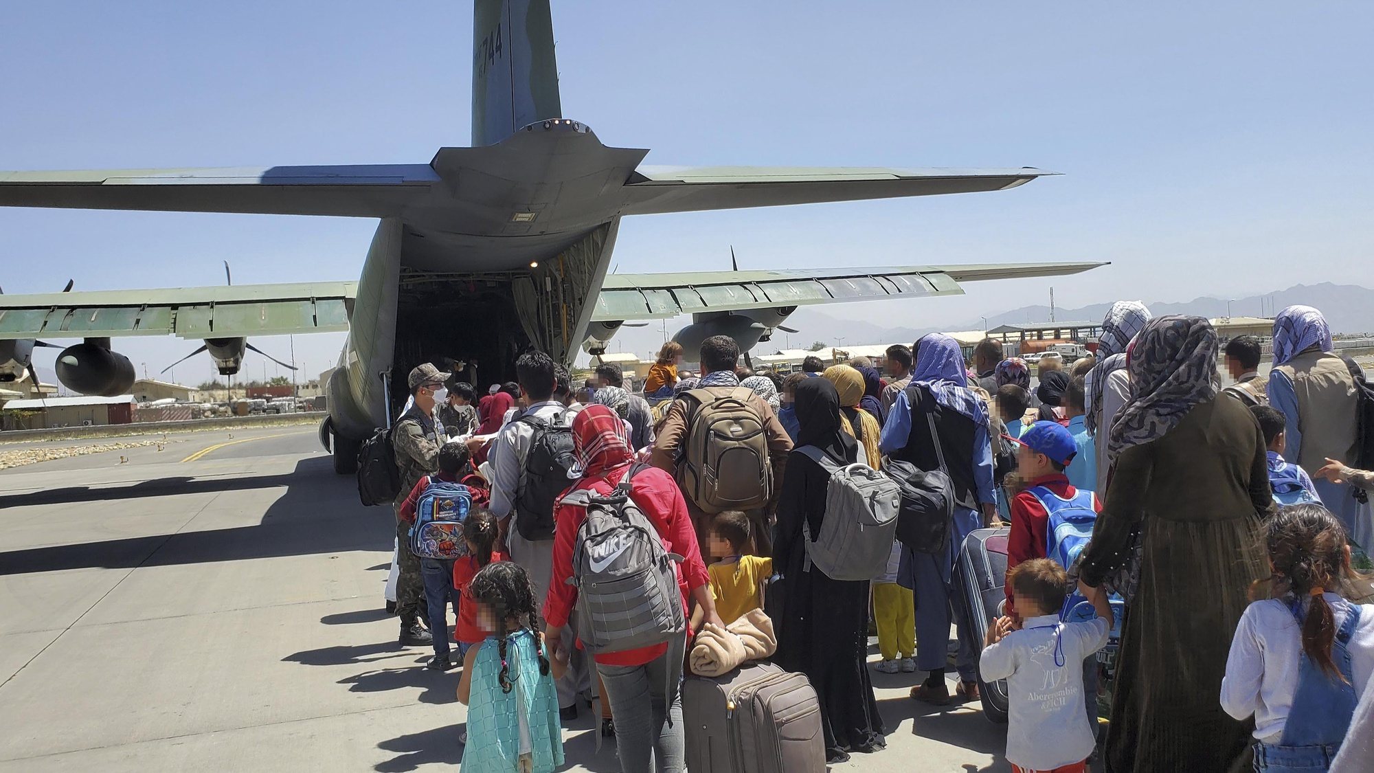epa09429709 A handout photo made available by the Republic of Korea Air Force shows some 380 Afghans who have worked for South Koreans in their war-ravaged nation and their family members boarding a South Korea military plane at an airport in Kabul, Afghanistan, 25 August 2021, to head for South Korea. EPA/REPUBLIC OF KOREA AIR FORCE / HANDOUT SOUTH KOREA OUT ATTENTION EDITORS: IMAGE PIXELATED AT SOURCE HANDOUT EDITORIAL USE ONLY/NO SALES