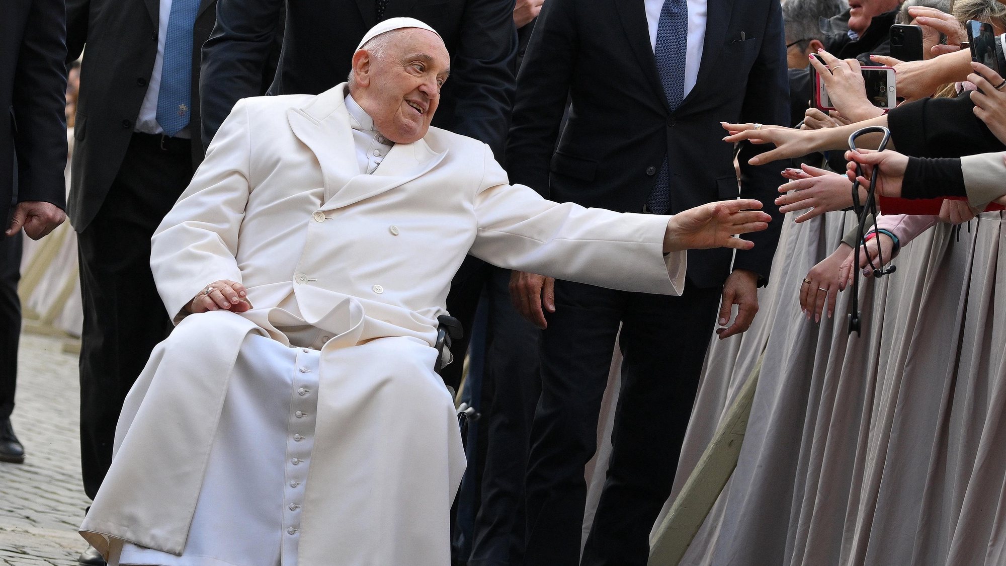epaselect epa11201590 Pope Francis, sitting on a wheelchair, greets the faithful as he leaves at the end of his weekly general audience in Saint Peter&#039;s Square, Vatican City, 06 March 2024.  EPA/ETTORE FERRARI