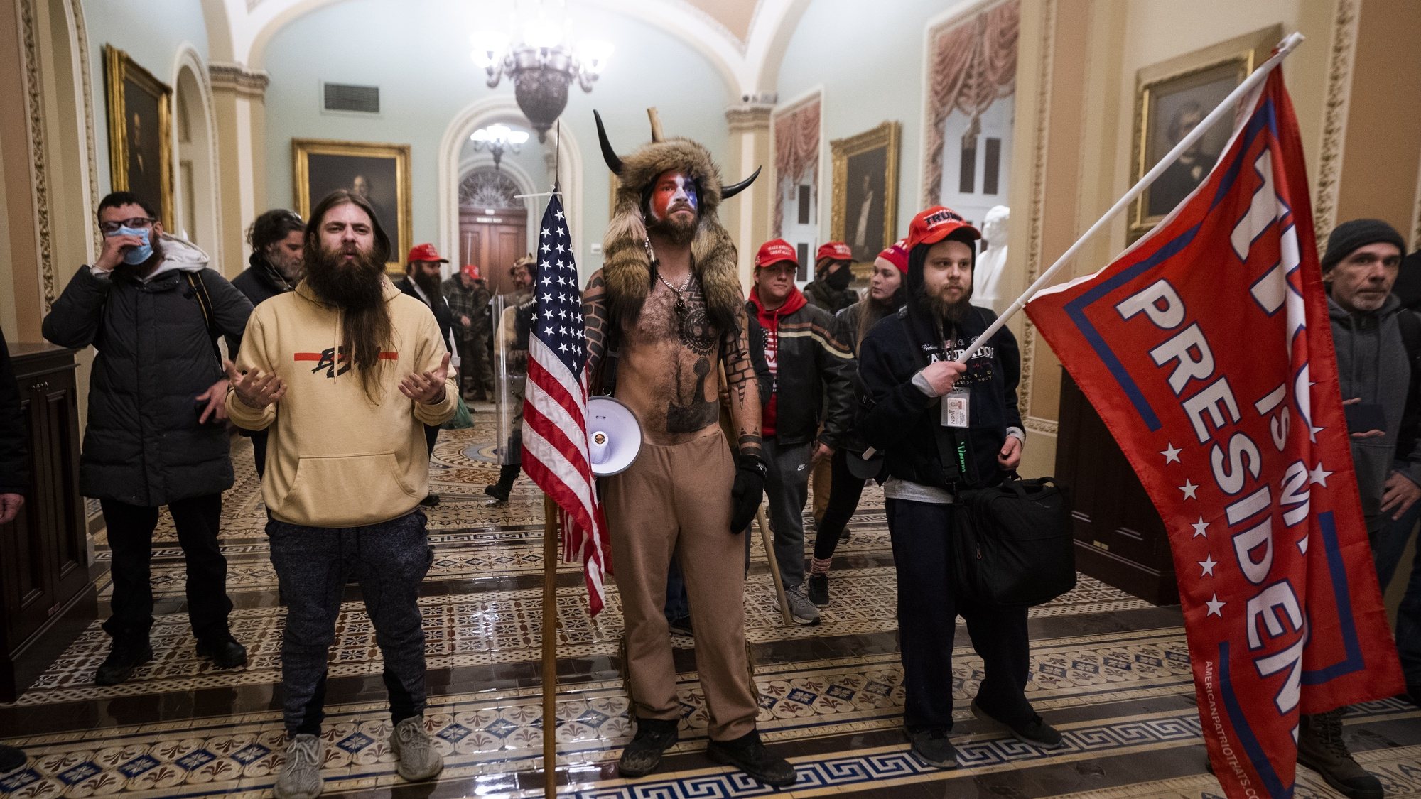 epa09664285 (14/24) (FILE) - Supporters of US President Trump stand by the door to the Senate chambers after they breached the US Capitol security in Washington, DC, USA, 06 January 2021 (reissued 03 January 2021). Following the November 2020 US presidential election, a tone set by supporters of defeated US President Donald Trump escalated further. Trump, who was refusing to concede the victory of Joe Biden, claiming voter fraud and rigged elections, told supporters and white nationalist extreme-right group Proud Boys to respectively &#039;Stop the Steal&#039; and to &#039;stand back and stand by&#039;. His social media accounts were suspended and the alt-right platform Parler gained in user numbers. On 06 January 2021, incumbent US vice president Pence was due to certify the Electoral College votes before Congress, the last step in the process before President-elect Biden was to be sworn in. In the morning, pro-Trump protesters had gathered for the so-called Save America March. Soon after Trump finished his speech at the Ellipse, the crowd marched to the Capitol. The attack had begun. Rioters broke into the Capitol building where the joint Congress session was being held. Lawmakers barricaded themselves inside the chambers and donned tear gas masks while rioters vandalized the building, some even occupying offices such as House Speaker Pelosi&#039;s. Eventually in the evening the building was cleared from insurrectionists, and the Congress chambers reconvened their session, confirming Joe Biden as the winner of the 2020 US presidential election. In the aftermath, more than 600 people were charged with federal crimes in connection to the insurgency, and close Trump aides such as Steve Bannon, Mark Meadows and Roger Stone were subpoenaed by the House select committee investigating the attack. Trump himself was acquitted by the Senate in his second impeachment trial, this time for &quot;inciting an insurrection&quot;. EPA/JIM LO SCALZO ATTENTION: This Image is part of a PHOTO SET *** Loc