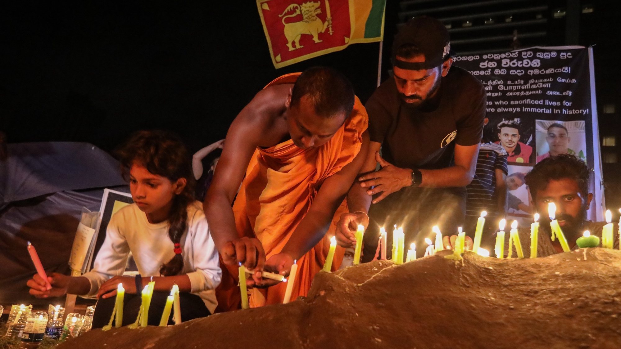 epa10074757 People light candles in memory of the protesters who were allegedly killed or wounded during the months-long protests and clashes against the economic crisis, near the Presidential Secretariat in Colombo, Sri Lanka, 16 July 2022. The Parliament of Sri Lanka accepted the resignation of President Gotabaya Rajapaksa after he fled to Singapore through the Maldives following months of anti-government protests fueled by the ongoing economic crisis. Protests have been rocking the country for over four months as Sri Lanka faces its worst-ever economic crisis in decades due to the lack of foreign reserves, resulting in severe shortages in food, fuel, medicine, and imported goods.  EPA/CHAMILA KARUNARATHNE