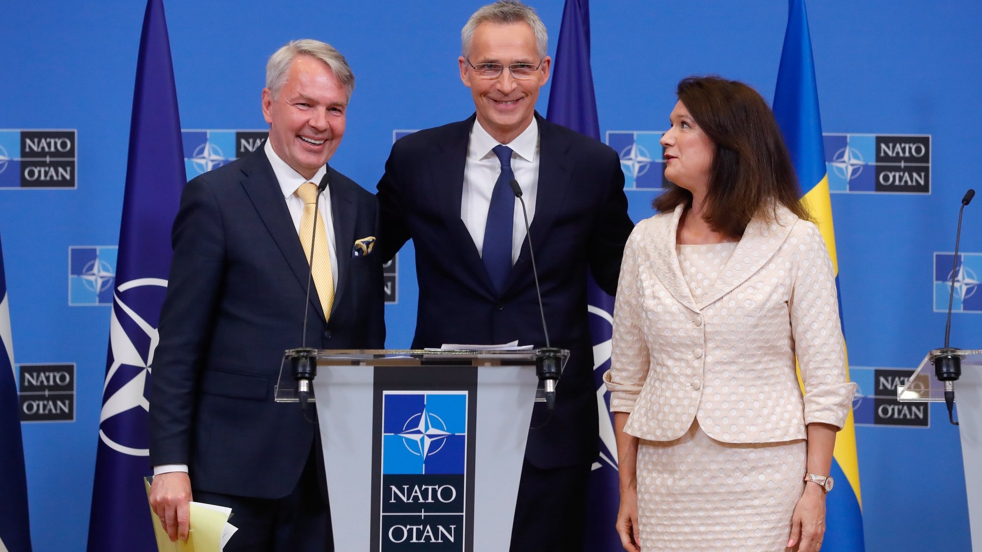 epa10052961 NATO Secretary General Jens Stoltenberg (C), Finland&#039;s Minister of Foreign Affairs Pekka Haavisto (L) and Sweden&#039;s Minister of Foreign Affairs Ann Linde pose for a picture at the end of a joint press conference after the signature of the accession protocols to NATO of Finland and Sweden, at NATO headquarters in Brussels, Belgium, 05 July 2022.  EPA/STEPHANIE LECOCQ