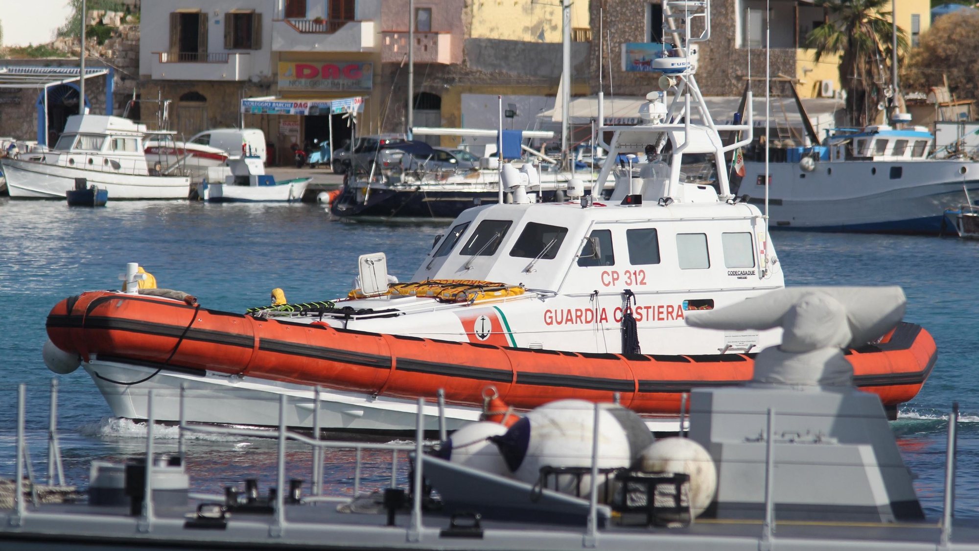epa07927791 An Italian Coast Guard boat arrives with the coffins containing the bodies of seven migrants recovered from a migrant boat that capsized and sunk on 07 October, in Lampedusa, Sicily island, southern Italy, 17 October 2019. Some 13 people - 12 of them women are reported dead on 07 October when a small boat full of migrants capsizes off Lampedusa.  EPA/PASQUALE CLAUDIO MONTANA LAMPO