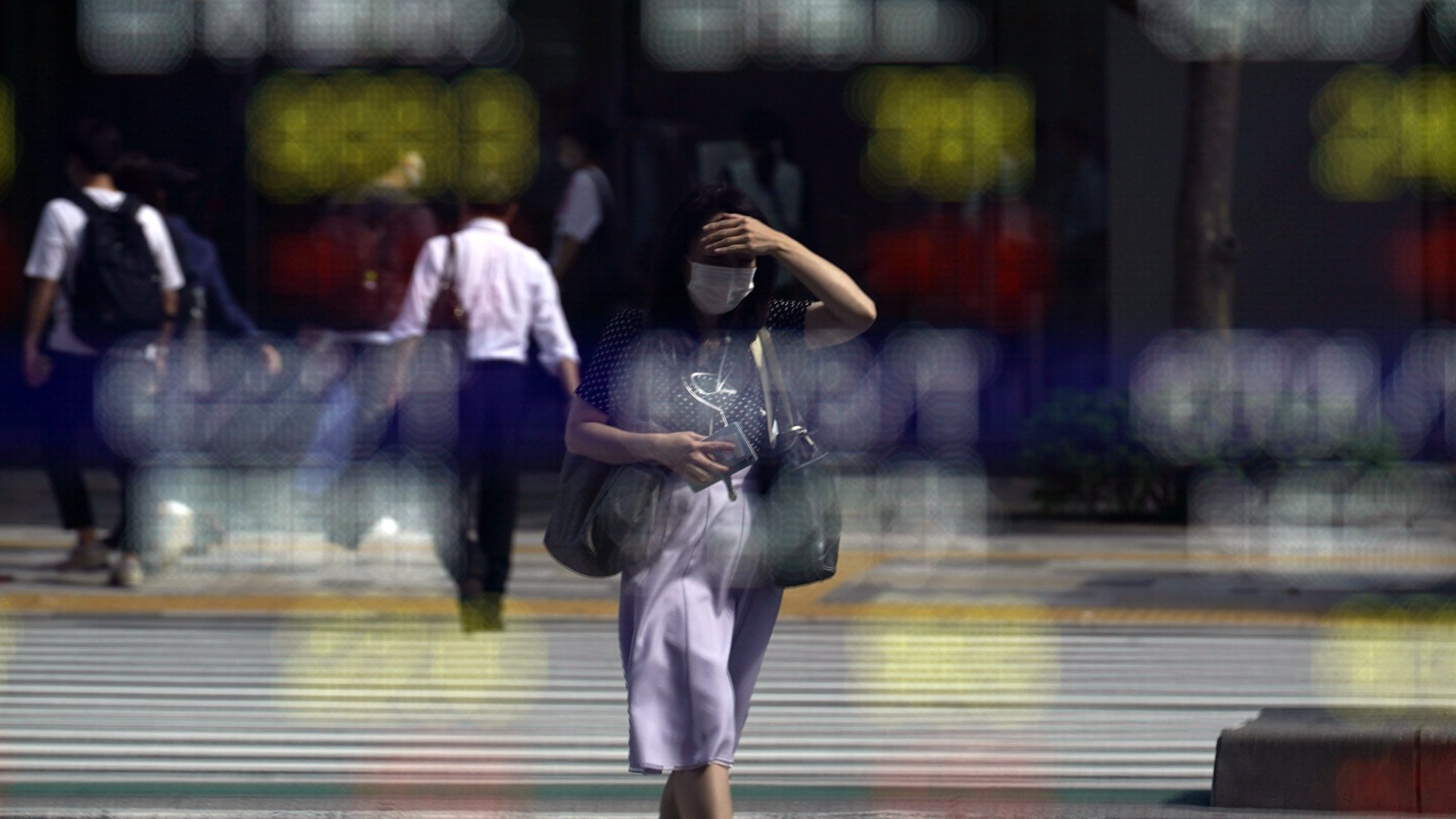 epa09512505 A passerby is reflected in a stock market indicator board in Tokyo, Japan, 08 October 2021. Tokyo stocks rose following overnight Wall Street gains after the US Senate reached a deal to suspend the debt limit until December, temporarily averting default. The 225-issue Nikkei Stock Average gained 370.73 points, or 1.34 per cent, to close at 28,048.94.  EPA/FRANCK ROBICHON