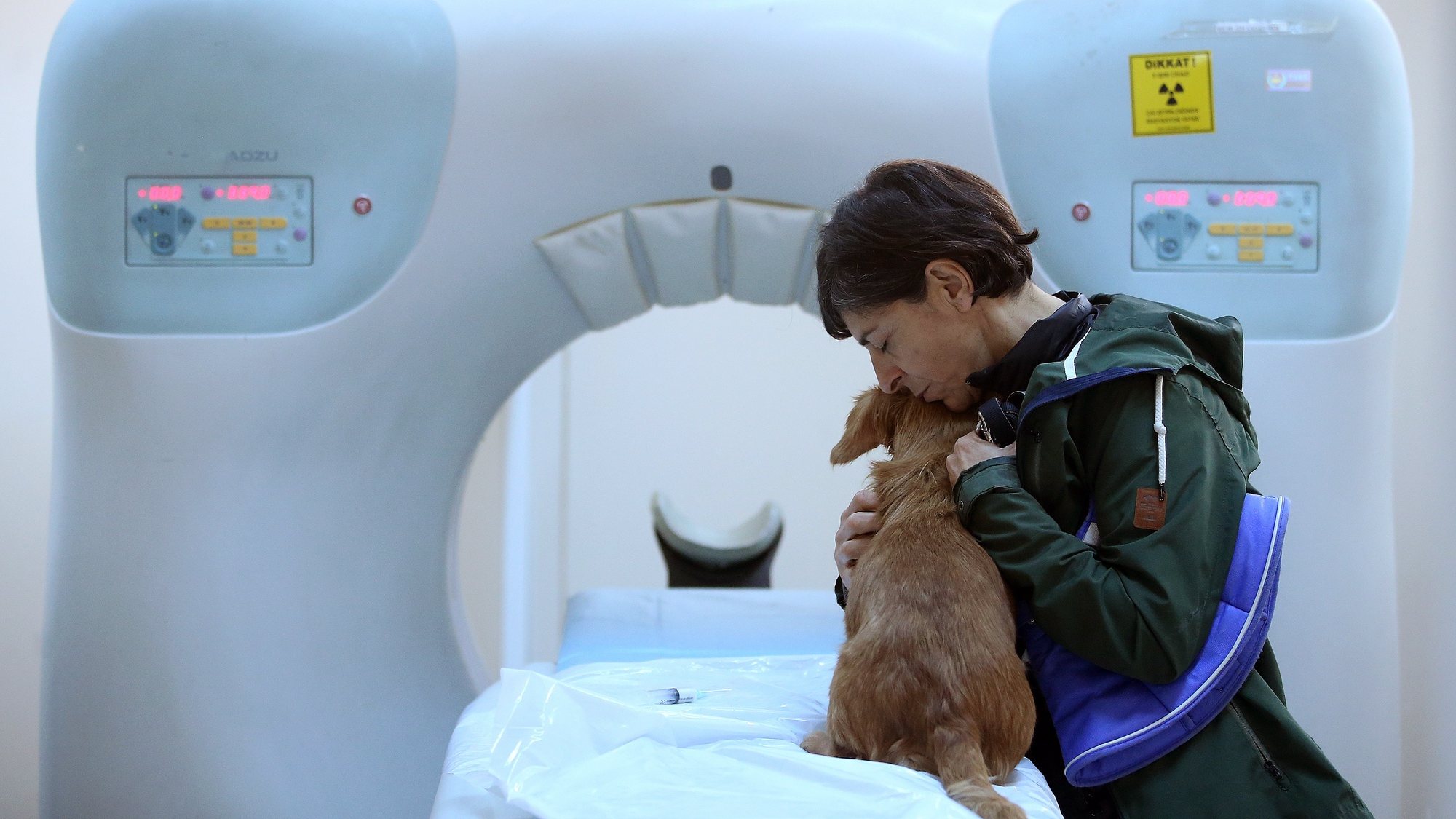 epa07250035 (06/23) A woman hugs her dog before it gets a narcosis for tomography screening at the Istanbul University Cerrahpasa Faculty of Veterinary Science Hospital in Istanbul, Turkey, 13 December 2018. The Istanbul University Cerrahpasa Faculty of Veterinary Science Hospital in the Turkish city of Istanbul opened in 1987 and treats thousands of sick animals every year. The hospital is split into five departments specializing in internal diseases, surgery, obstetrics and gynecology, artificial insemination and wild animal reproduction. It also has an emergency room that is staffed 24 hours a day. The hospital treats some 50,000 animals every year, mostly pets, and is funded by vet bills paid by owners.  EPA/ERDEM SAHIN    ATTENTION: For the full PHOTO ESSAY text please see Advisory Notice epa07250029