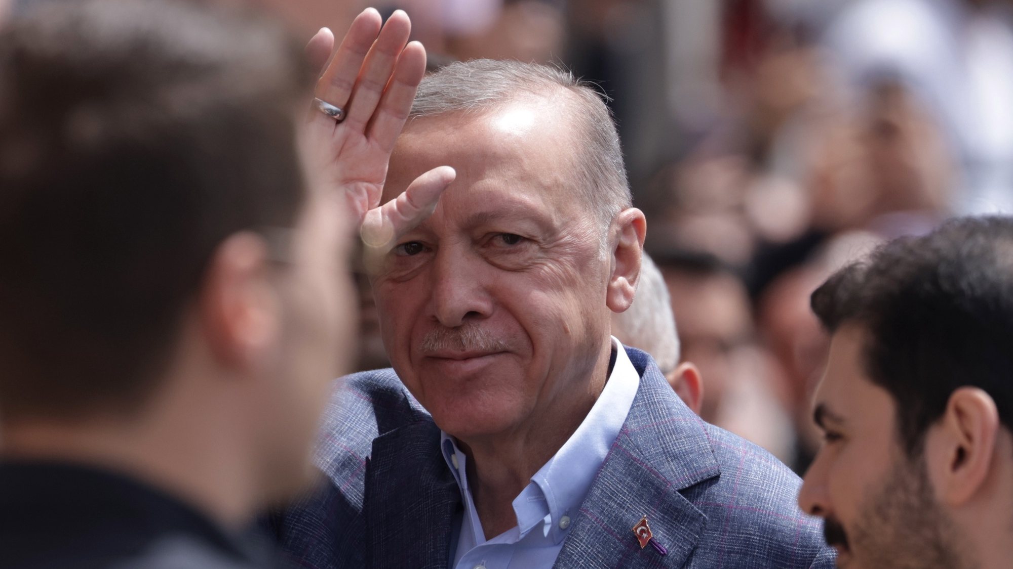 epa10626900 Turkish President Erdogan greets his supporters before he votes for the general elections, at a polling stsation in Istanbul, Turkey, 14 May 2023, as the country holds simultaneous parliamentary and presidential elections.  EPA/ERDEM SAHIN