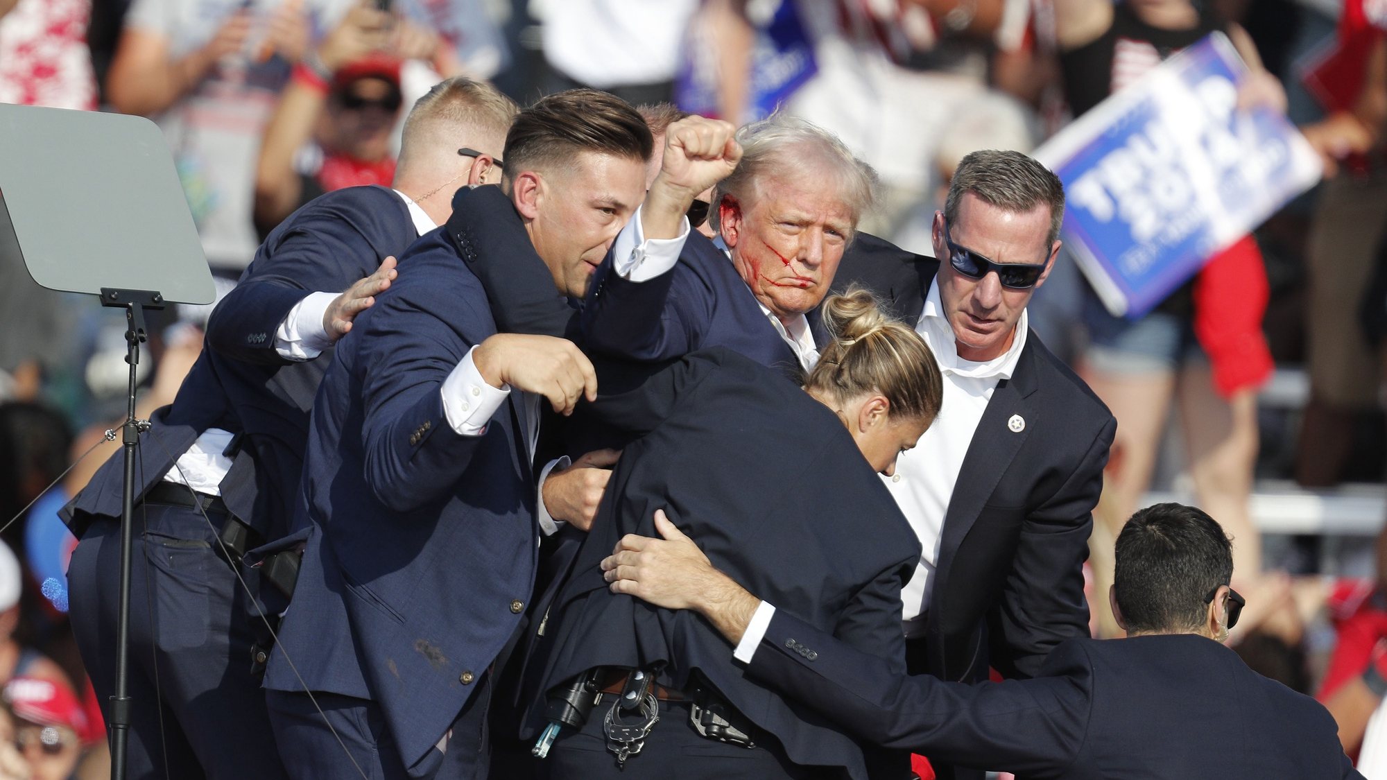 epa11476746 Former US President Donald Trump is rushed off stage by secret service after an incident during a campaign rally at the Butler Farm Show Inc. in Butler, Pennsylvania, USA, 13 July 2024.  EPA/DAVID MAXWELL