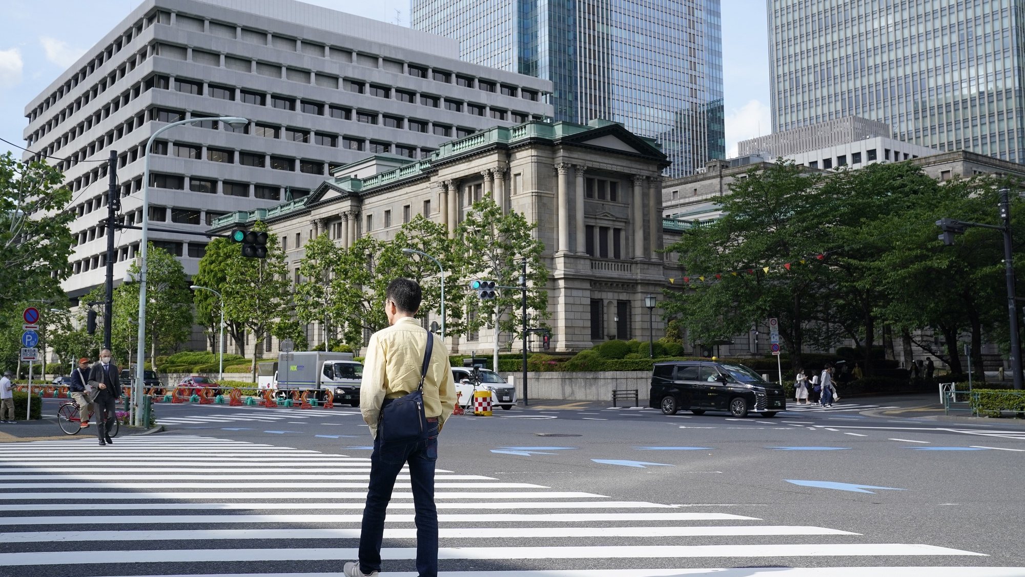 epa11313897 Pedestrians walk past the Bank of Japan headquarters in Tokyo, Japan, 02 May 2024. After US Federal Reserve Chair Jerome Powell&#039;s news conference, the exchange rate of the Japanese yen against the US dollar early on 02 May 2024 soared more than four yen against the dollar from the mid-157 yen level to the 153 yen level. Japanese Vice Finance Minister Masato Kanda has not told whether the government and the Bank of Japan implemented the intervention to the yen and the US currency market or not.  EPA/KIMIMASA MAYAMA