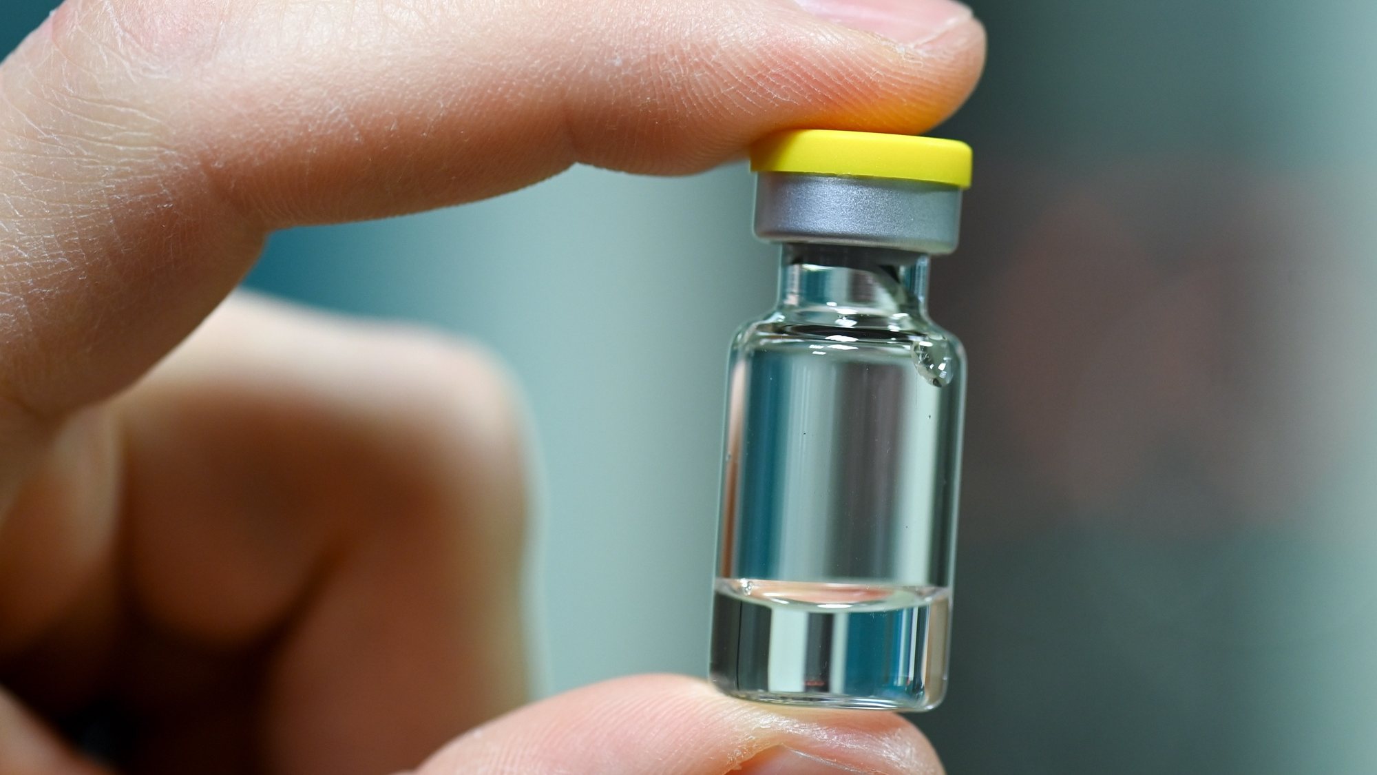 epa08837600 An employee holds an ampoule into which the vaccine is later filled at the vaccine manufacturer IDT Biologika&#039;s plant in Dessau-Rosslau, Germany, 23 November 2020. German Health Minister Jens Spahn announced the planned purchase of five million coronavirus vaccine doses. According to the scientific director, IDT expects to go into commercial production of the coronavirus vaccine in the middle of next year.  EPA/HENDRIK SCHMIDT / POOL