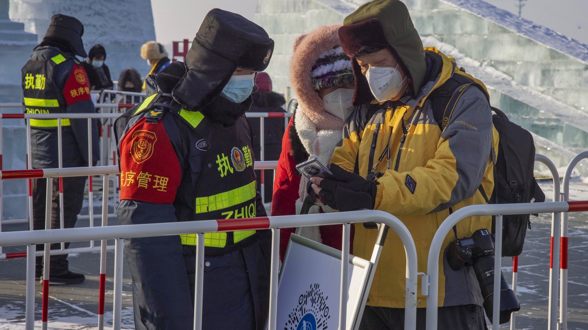epa08939904 Security officers check people&#039;s health QR codes and measure their body temperature in Harbin, Heilongjiang province, China, 15 January 2021. According to the National Health Commission, there are 144 COVID-19 new cases reported in mainland China on 15 January. China&#039;s northeastern Heilongjiang province on 13 January declared a state of emergency as the outbreak spreads. Suihua city on the border with Russia has been locked down as well as other small cities nearby. The latest outbreak happened in Hebei province near Beijing. The capital city Shijiazhuang, Xingtai and Langfang cities, are also sealed. Other provinces and cities have imposed strict measures and 14 days of quarantine for returning home residents. The Chinese government discourages people from traveling during the Lunar New Year festival, which is the biggest human migration in the world. The government advises citizens to stay safe and gather with their families online.  EPA/ALEX PLAVEVSKI