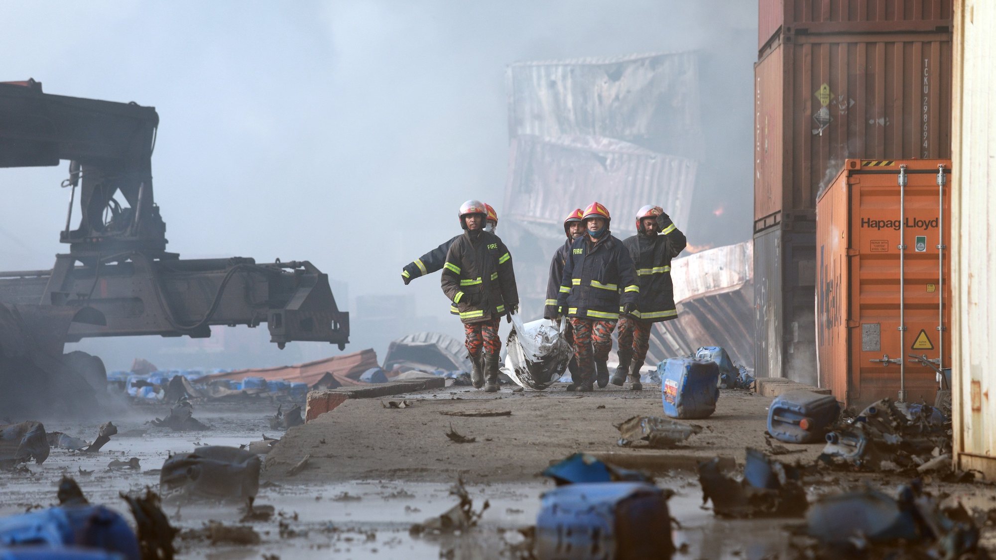 epa09996817 Firefighters shift body bags of victims of a massive fire at BM container depot in Shitalpur, Sitakunda Upazela, Chattogram, Bangladesh, 05 June 2022. At least 35 people are dead and over 450 are injured during a massive fire caused by an explosion at a private chemical container depot, according to the Fire services and the Police. The fire broke out at BM Container Limited in Shitalpur area in Chattogram around 10 pm last night, 29 firefighter units worked to put out the fire.  EPA/STR