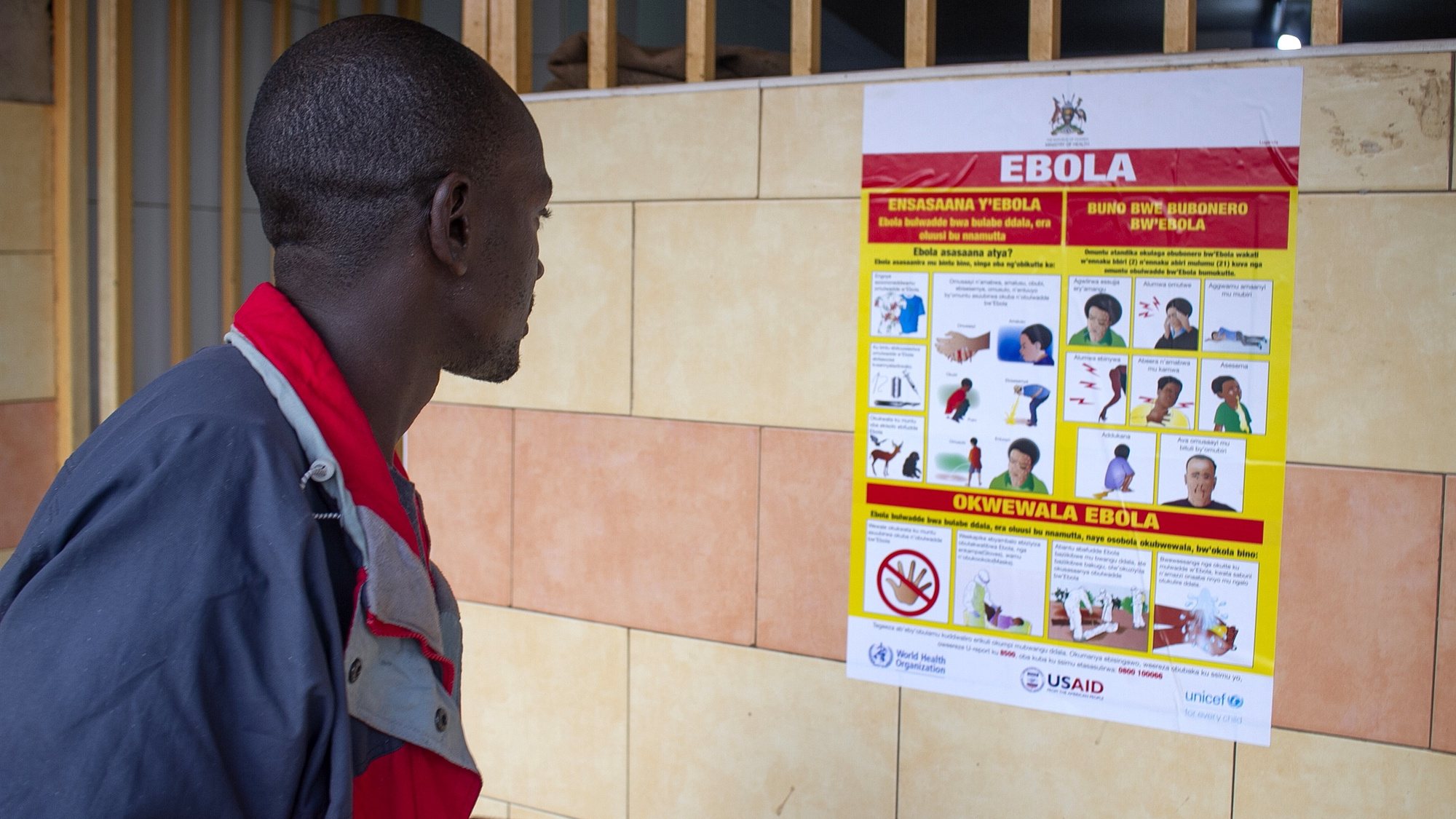 epa10212384 A man looks at an Ebola virus disease awareness campaign poster following an outbreak of Ebola in Uganda, in Kampala, Uganda, 28 September 2022. According to Uganda&#039;s Health Ministry, Ebola infections have risen across some districts in Uganda with the number of confirmed and suspected deaths at 36. The president addressed the nation on measures the government is putting in place to mitigate the spread.  EPA/Stringer
