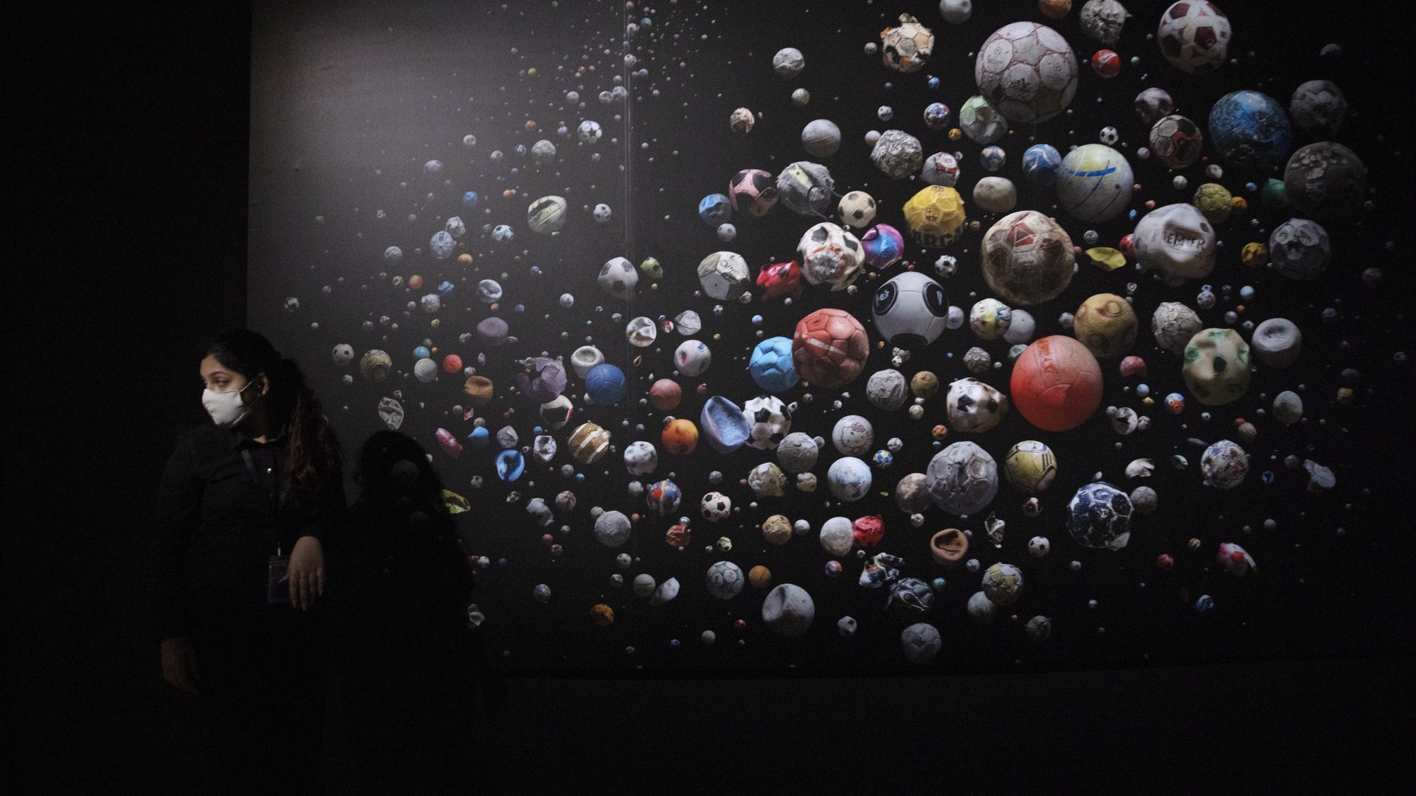 epa08672603 A staff member walks past British photographer Mandy Barker&#039;s work featuring 633 soccer balls collected on 104 beaches from 23 countries and islands in Europe by 62 people in four months, on display at the &#039;Planet or Plastic?&#039; exhibition at the ArtScience Museum in Singapore, 16 September 2020. The exhibition is a collaboration between National Geographic and the ArtScience Museum featuring visuals and artworks to raise awareness of society&#039;s dependence on plastics and the impact of its pollution on the world&#039;s oceans and marine animals.  EPA/HOW HWEE YOUNG