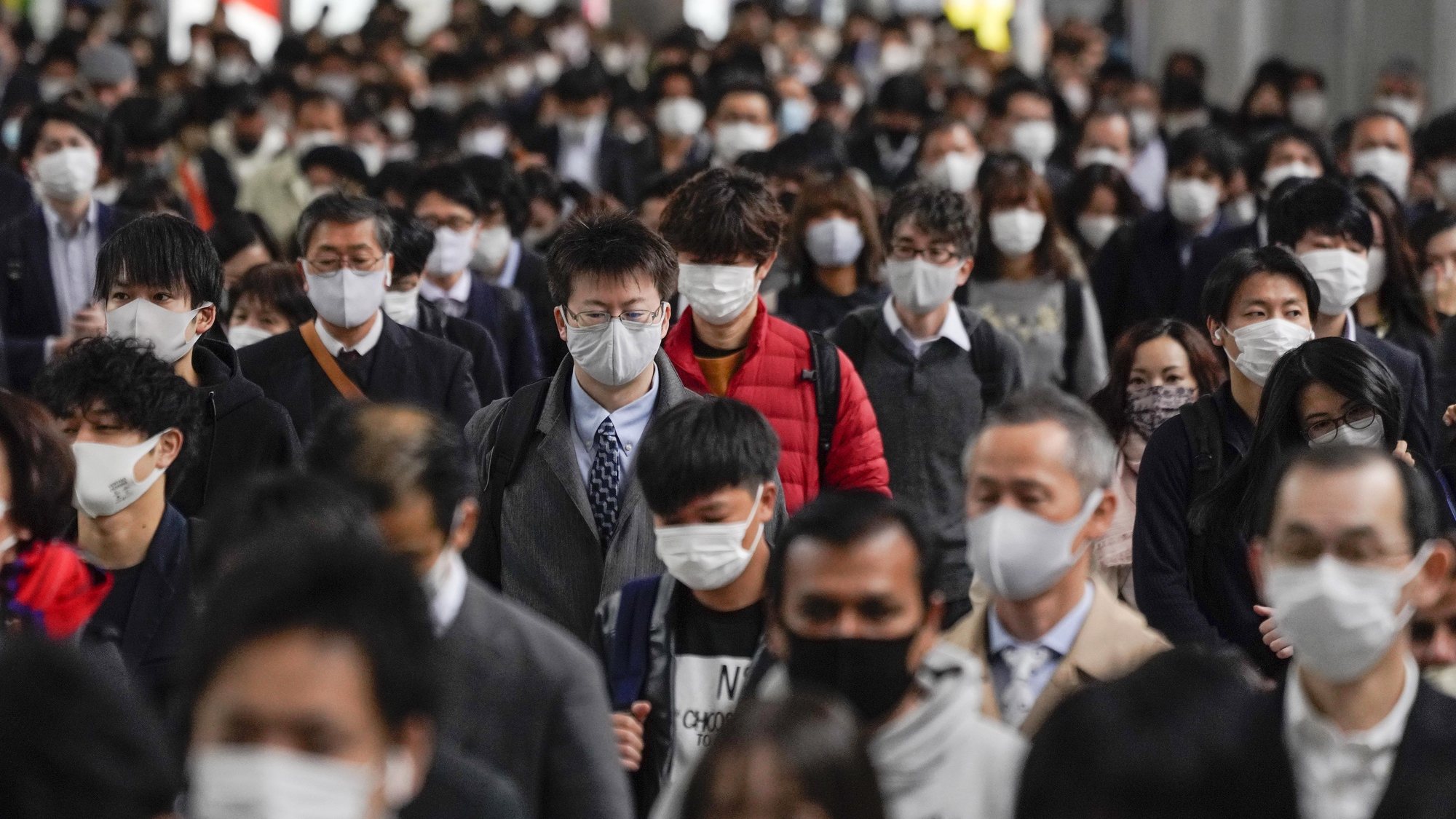 epa08897237 (FILE) - (FILE) Commuters walk to work after exiting from their packed commuter trains at Shinagawa railway station in Tokyo, Japan, 24 November 2020 (reissued 21 December 2020). According to latest media reports, the total number of coronavirus disease (COVID-19) infections in Japan has exceeded the 200,000 mark since the start of the pandemic.  EPA/KIMIMASA MAYAMA