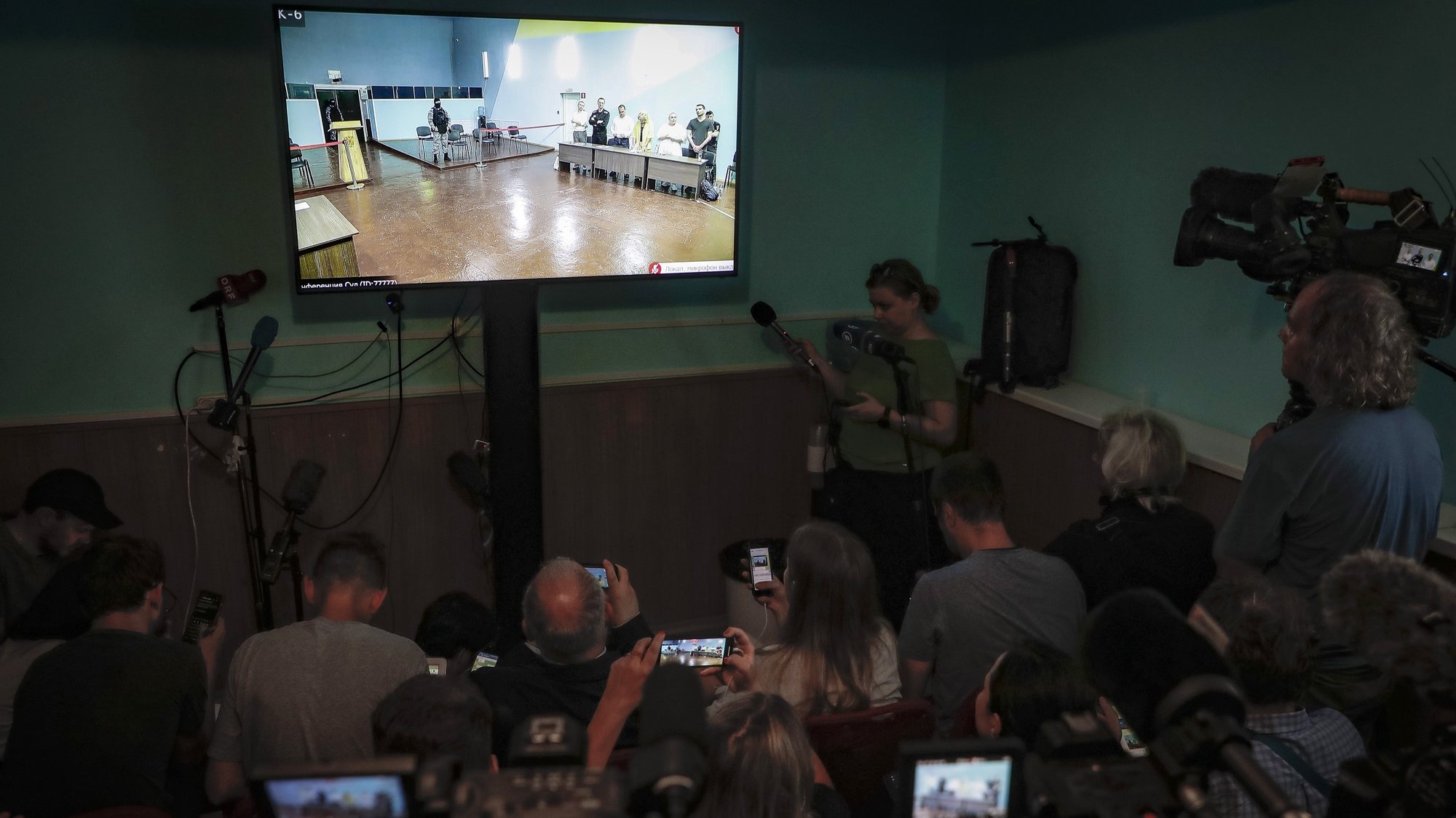 epa10784484 Russian opposition figure Alexei Navalny (4-L) is seen on a screen during an offsite verdict hearing of the Moscow city court in the case of Russian opposition figure Alexei Navalny in Melekhovo, Vladimir region, about 260 kilometers of Moscow, Russia, 04 August 2023. Navalny has been in the colony since February 2021, when the court, at the request of the Federal Penitentiary Service, replaced his suspended sentence in the Yves Rocher case of 2014 with a real one. He was supposed to serve in a penal colony for 2 years and 8 months, but in March 2022, the Lefortovo Court of Moscow, at an off-site meeting in correctional colony in the city of Pokrov, Vladimir Region, sentenced the politician to 9 years of strict regime and a fine of 1.2 million rub., as well as one and a half years of restriction of freedom in the case of fraud and contempt of court. In June 2023 Navalny went on trial on new charges of extremism. The сourt sentenced politician Alexei Navalny to 19 years in a strict regime colony.  EPA/MAXIM SHIPENKOV