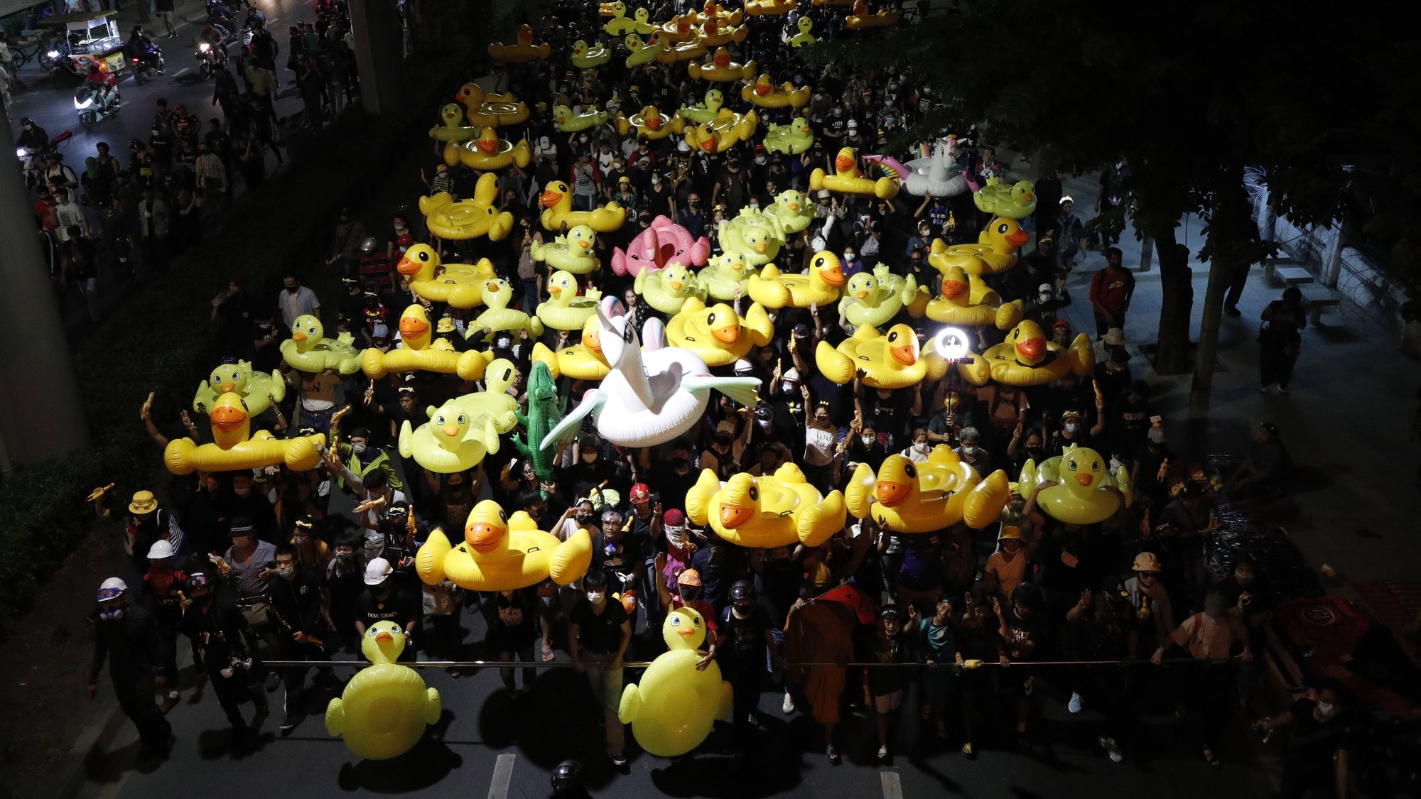 epaselect epa08850460 Anti-government protesters march with inflatable rubber ducks during a street protest calling for a political and monarchy reform at the 11th Infantry Regiment, the headquarters of the King&#039;s Guard regiment in Bangkok, Thailand, 29 November 2020. Thailand&#039;s politics intensified by months-long street protests calling for the political and monarchy reform and the resignation of the prime minister.  EPA/RUNGROJ YONGRIT