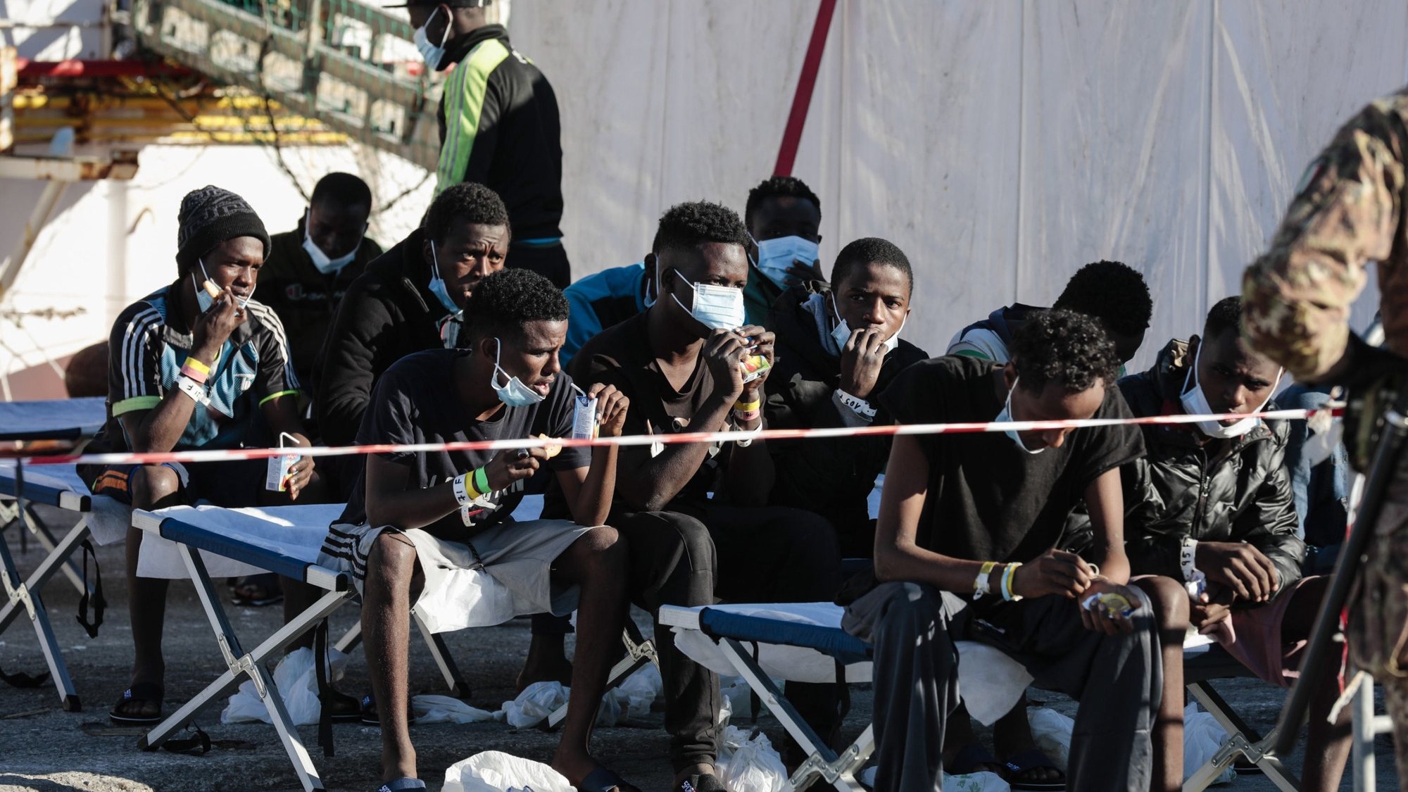 epa09662409 Some of the 440 migrants disembark from &#039;SeaWatch 3&#039; who entered port the previous day, in Pozzallo, Sicily, Italy, 01 January 2022. The German NGO migrant rescue ship Sea Watch 3 with 440 migrants on board arrived on 31 December 2021 in the port of Pozzallo. The ship was at sea since Christmas Eve after carrying out five rescue missions.  EPA/FRANCESCO RUTA