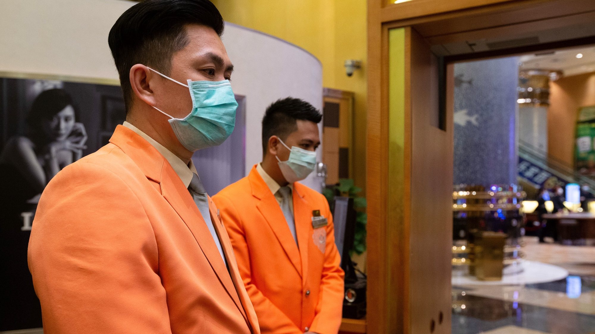 epa08228738 Casino workers wearing protective masks await customers as the Casino reopens in Macao, China, 20 February 2020. Twenty-nine casinos are to reopen starting 20 February, and 12 remain closed, the authorities of the gambling capital said, one of the regions that have identified cases of infection by the coronavirus Covid-19.  After 15 days of closure, Macau&#039;s government said on 17 February that the casinos could reopen, giving operators 30 days to return to business.  EPA/CARMO CORREIA