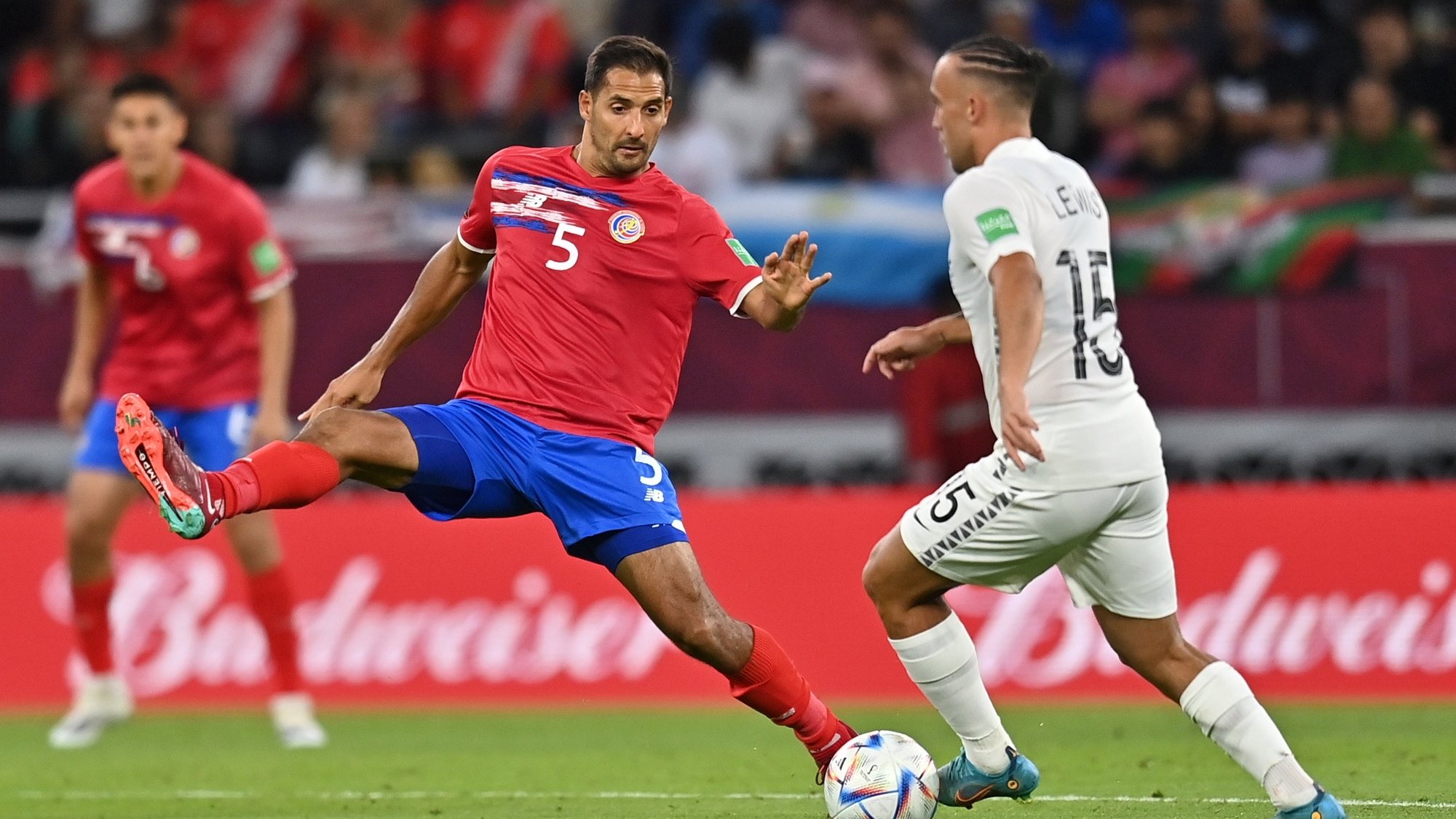 epa10013175 Celso Borges (L) of Costa Rica in action against Clayton Lewis of New Zealand during the FIFA World Cup 2022 Intercontinental playoff qualifying soccer match between Costa Rica and New Zealand in Al Rayyan, Qatar, 14 June 2022.  EPA/Noushad Thekkayil