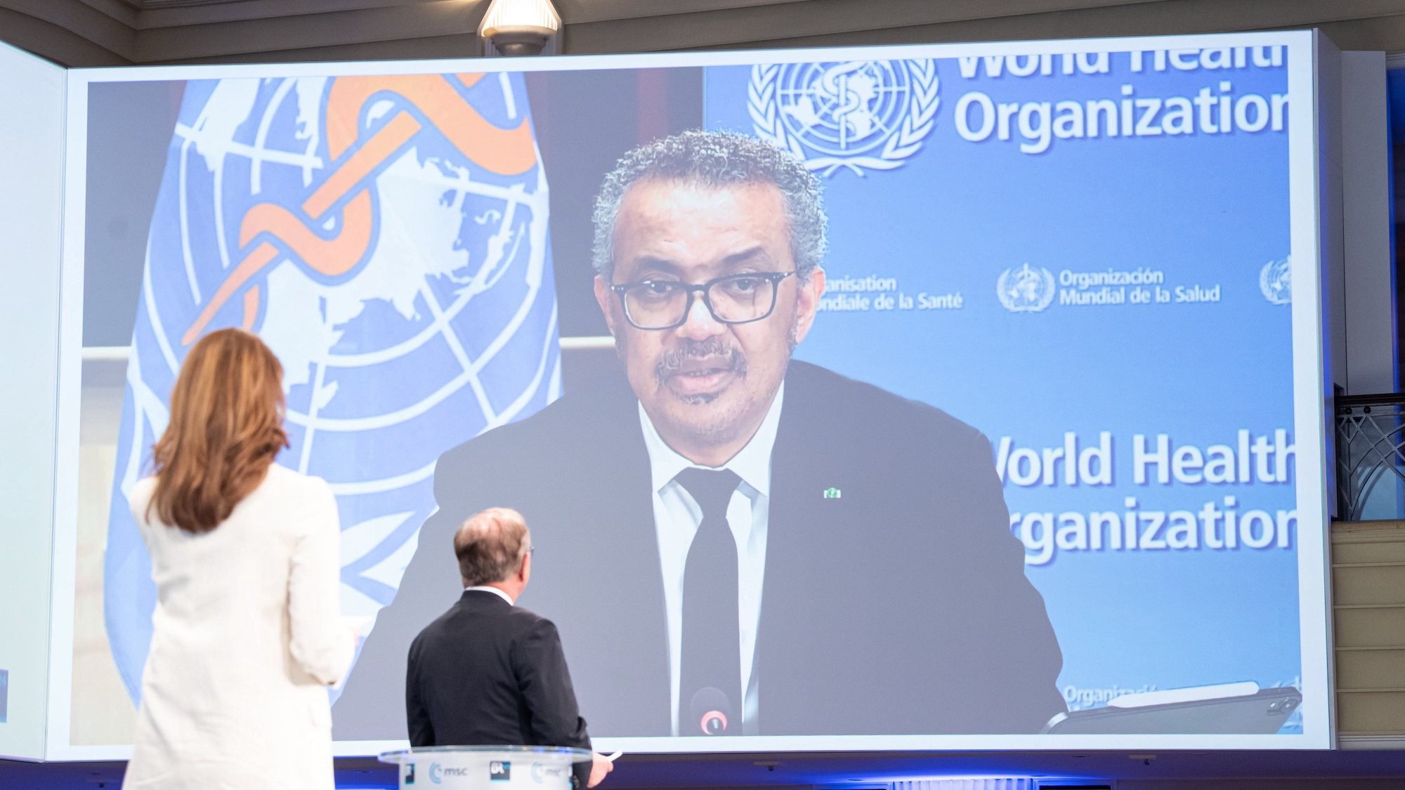 epa09024217 A handout photo made available by the Munich Security Conference (MSC) shows shows Tedros Adhanom Ghebreyesus (screen), Director General of the World Health Organization (WHO) speaking during the Munich Security Conference 2021 Special Edition, in Munich, Bavaria, Germany, 19 February 2021. Some international decision-makers discuss on international security policy in a live broadcast during the MSC Special Edition. Due to the pandemic, the 57th Munich Security Conference is postponed at a later date in 2021.  EPA/MSC/Mueller / HANDOUT  HANDOUT EDITORIAL USE ONLY/NO SALES