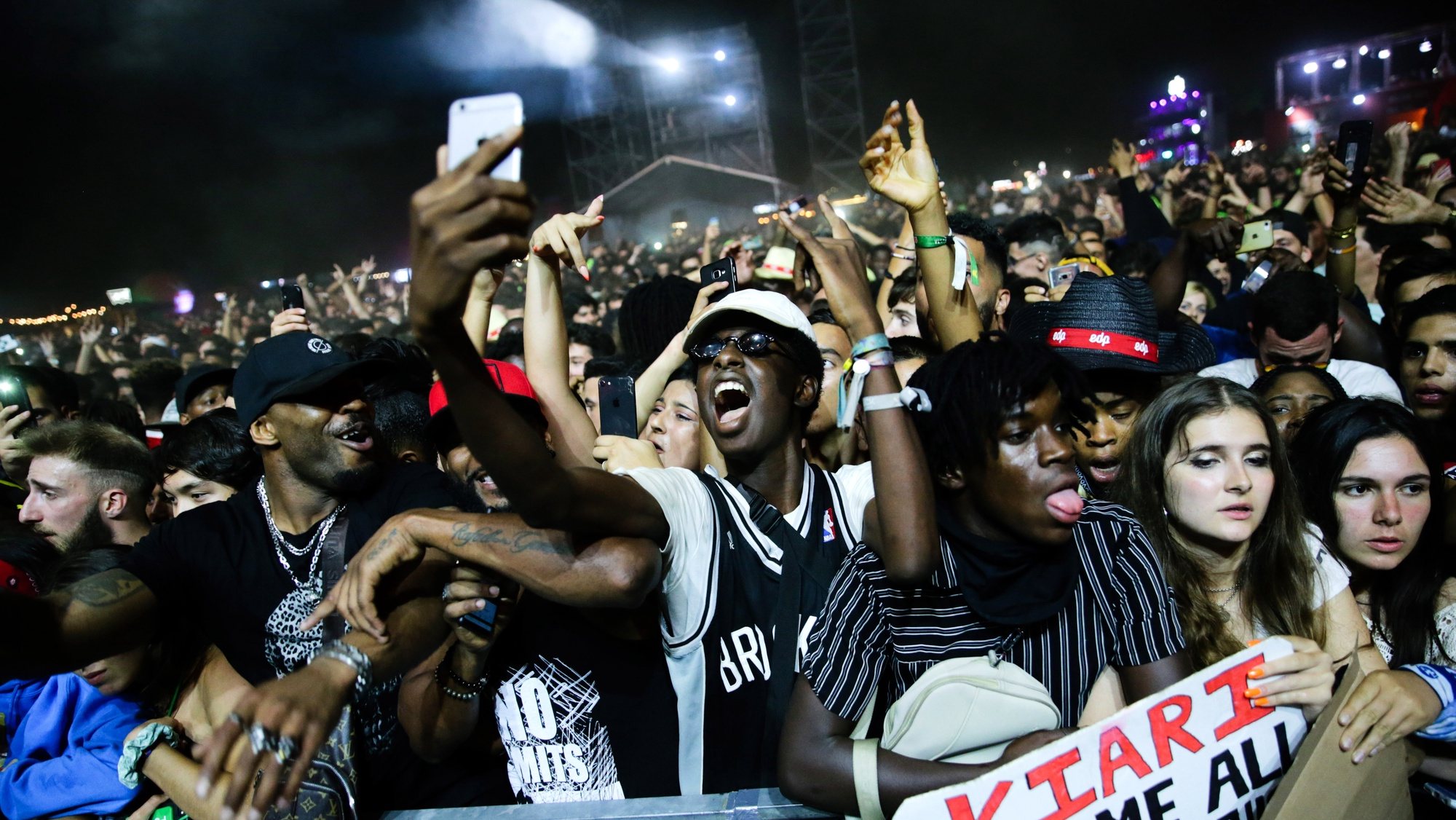 epa07730323 Festival goers singing on US hip hop group Migos performace on the third and last day of the 25th Super Bock Super Rock Festival in Meco, Sesimbra, Portugal, 20 July 2019.  EPA/TIAGO PETINGA