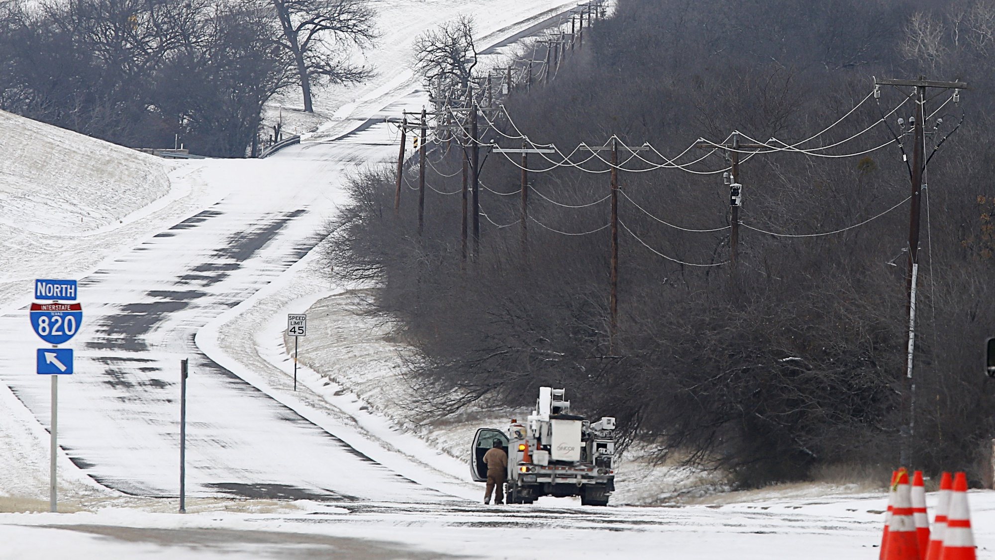 epa09020166 An Oncor Power truck and crew work along Loop 820 in Fort Worth, Texas, 17 February 2021. The electric grid in Texas run by the non profit Ercot, has been overwhelmed by high demand leaving millions without power in the state. Snow and cold weather have blanket North Texas for the fourth day in unseasonably cold weather, with overnight temperatures dropping to -10 degrees celsius in Fort Worth.  EPA/Ralph Lauer