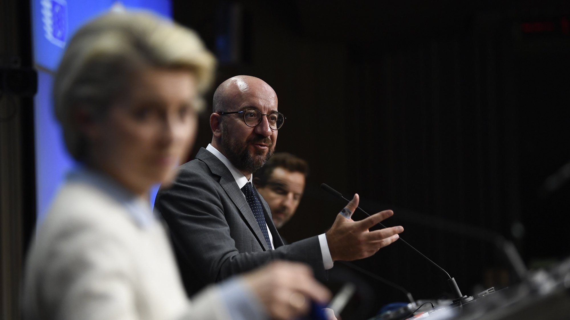 epa09225963 President of the European Commission Ursula von der Leyen (L) looks on as President of the European Council Charles Michel (R) speaks during a press conference at the EU summit at the European Council building in Brussels, Belgium, 24 May 2021. European Union leaders will take part in a two day in-person meeting to discuss the coronavirus pandemic, climate change and Russia.  EPA/JOHN THYS / POOL