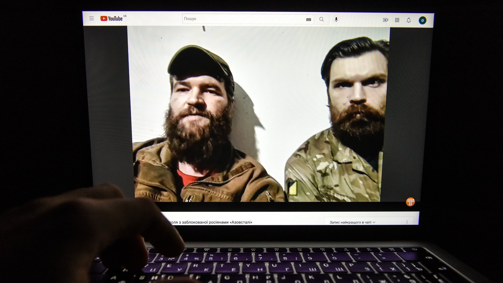epa09934781 A video of a press conference from the Azovstal steel plant in Mariupol by Azov regiment servicemen Illia Samoilenko (R) and Sviatoslav Palamar (L) is seen on a computer screen in Kyiv, Ukraine, 08 May 2022. On 24 February, Russian troops had entered Ukrainian territory in what the Russian president declared a &#039;special military operation&#039;, resulting in fighting and destruction in the country, a huge flow of refugees, and multiple sanctions against Russia.  EPA/OLEG PETRASYUK