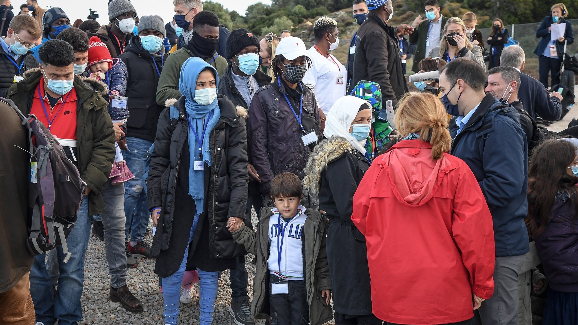 epa09623253 People gather at the Reception and Identification Centre (RIC) in Mytilene on the island of Lesbos, Greece, 05 December 2021. Pope Francis returned to the island of Lesbos, the migration flashpoint he first visited in 2016, to plead for better treatment of refugees as attitudes towards migrants harden across Europe.  EPA/ALESSANDRO DI MEO