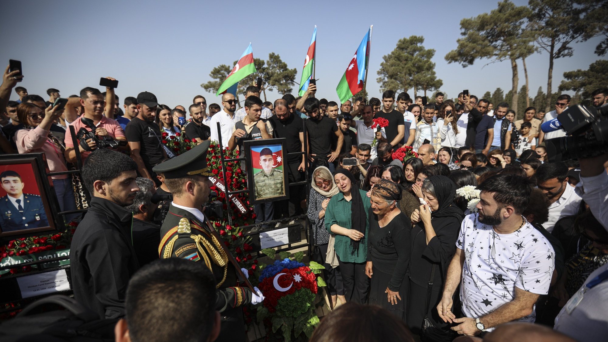 epa10183783 Azeri people stands near the grave of serviceman Sabuhi Ahmadov during mass funerals of Azeri servicemen who were killed during clashes with Armenian troops on the border with Armenia, at the cemetery near Baku, Azerbaijan, 14 September 2022. Armenia and Azerbaijan exchanged artillery fire on the night to 13 September, prompting fears of escalation, with both sides blaming each other for the initial provocations. According to the Armenian side, from midnight, Azerbaijan began to conduct intense fire in the direction of the settlements of Sotka, Goris and Jermuk in the southeast of the country from artillery pieces and large-caliber weapons. According to the Armenian Defense Ministry, at least 105 people from the Armenian side died as a result of the conflict. Baku and Yerevan, through the mediation of Moscow, were able to agree on a ceasefire from 09:00 Moscow time, the Russian Foreign Ministry reported. The Azerbaijani Defense Ministry reported that the reason for the aggravation was &#039;intensive shelling over the past month of the positions of the Azerbaijani army in the Kalbajar, Lachin, Dashkesan and Gedabek directions and large-scale provocations committed today,&#039; and placed all responsibility for what happened on the military leadership of Armenia. According to the information by the Azerbaijan Defence ministry, 50 Azeri servicemen have been killed in last two days.  EPA/ROMAN ISMAYILOV