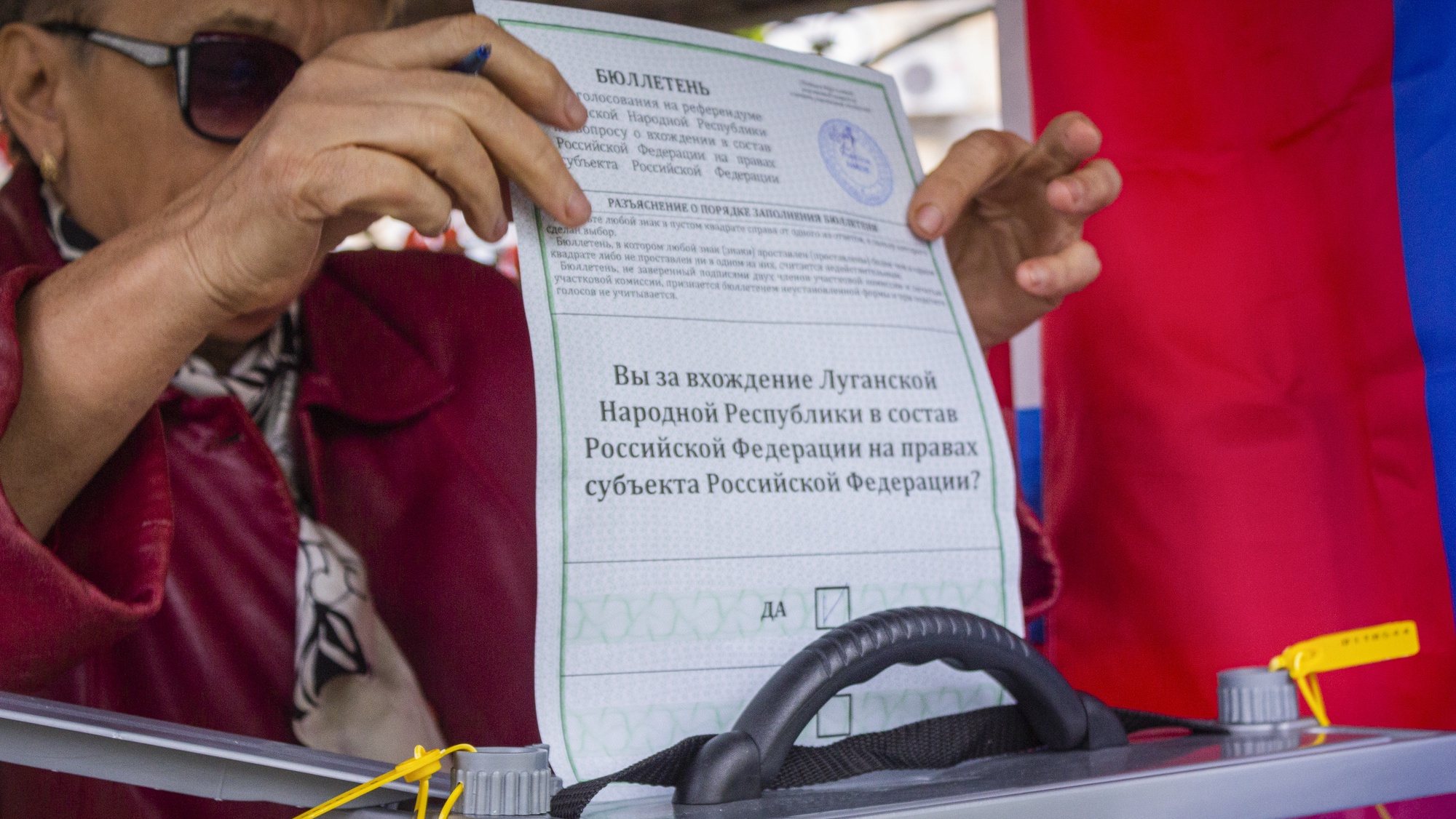 epa10203733 A woman cast her ballot during voting in a referendum, at an outdoor polling station in Luhansk, eastern Ukraine, 24 September 2022. From 23 to 27 September, residents of the self-proclaimed Luhansk and Donetsk People&#039;s Republics as well as the Russian-controlled areas of the Kherson and Zaporizhzhia regions of Ukraine vote in a referendum to join the Russian Federation. On 24 February 2022 Russian troops entered the Ukrainian territory in what the Russian president declared a &#039;Special Military Operation&#039;, starting an armed conflict that has provoked destruction and a humanitarian crisis.Â   EPA/STRINGER