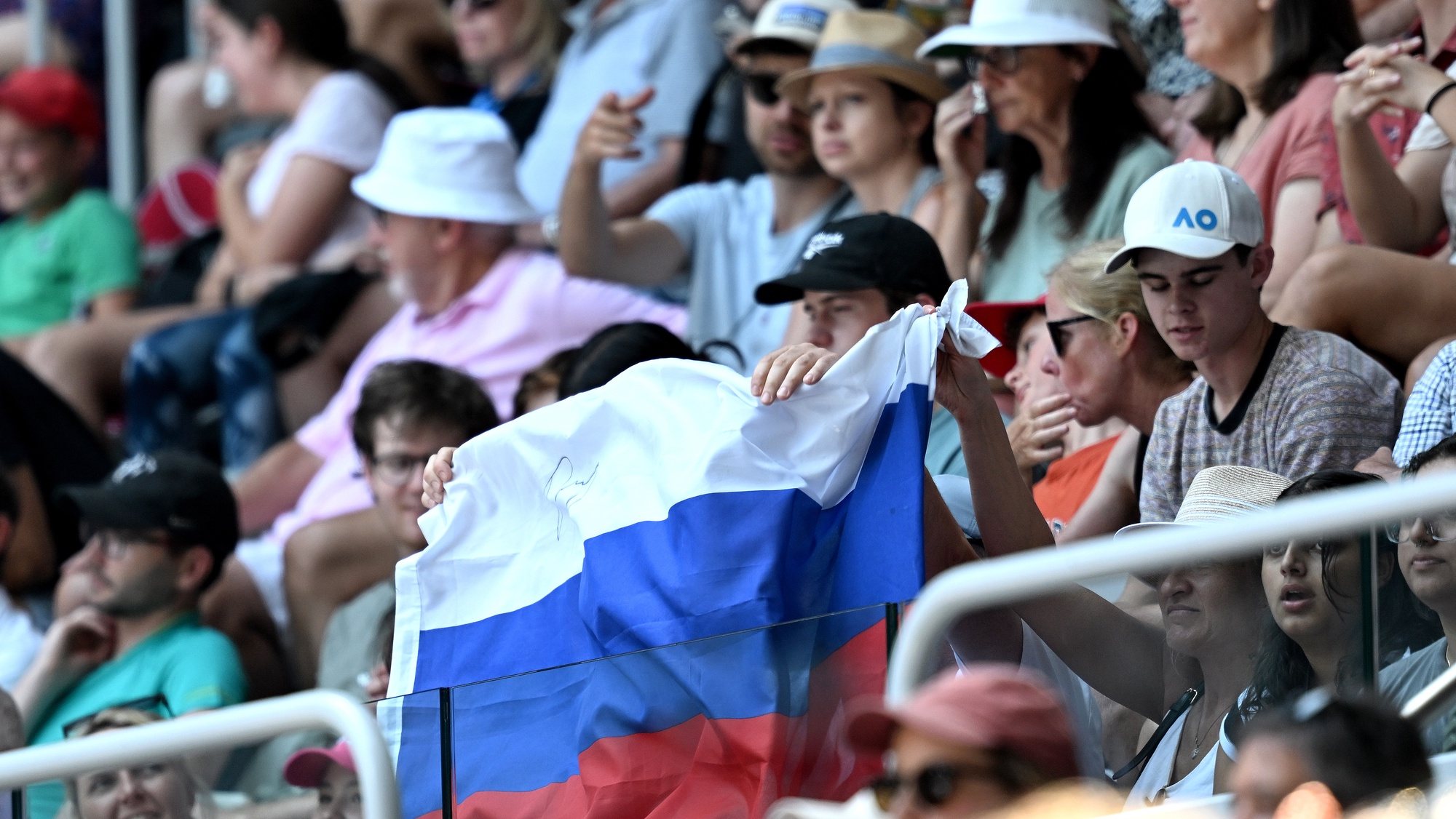 epa10409884 A Russian flag is displayed by spectators during the first round singles match between Andrey Rublev of Russia and Dominic Them of Austria at the 2023 Australian Open tennis tournament at Melbourne Park in Melbourne, Australia, 17 January 2023.  EPA/LUKAS COCH  AUSTRALIA AND NEW ZEALAND OUT