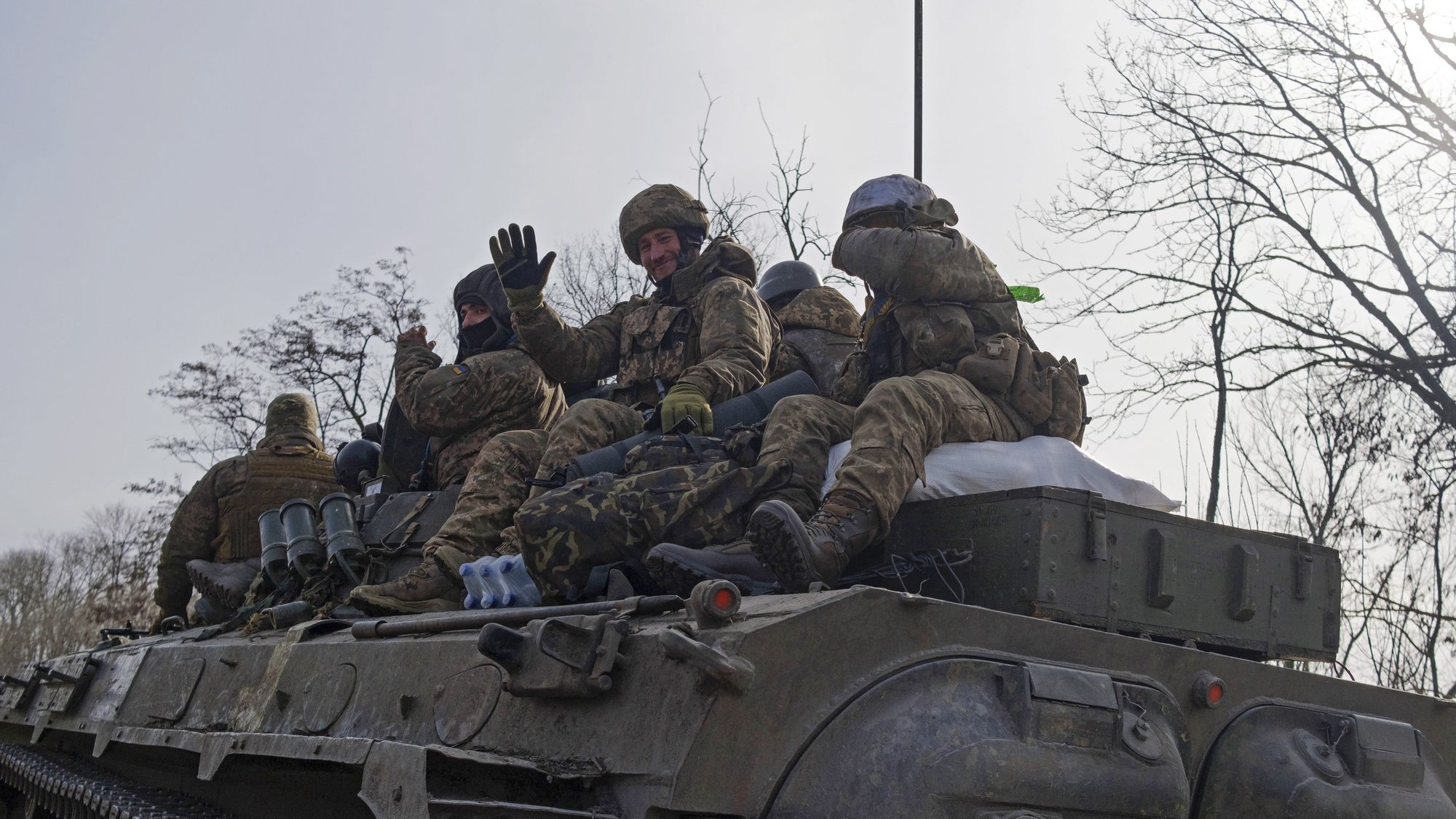 epa10489119 Ukrainian servicemen ride atop an APC on a road in Bakhmut, Ukraine, 24 February 2023. Russian troops entered Ukrainian territory on 24 February 2022, starting a conflict that has provoked destruction and a humanitarian crisis. One year on, fighting continues in many parts of the country.  EPA/GEORGE IVANCHENKO