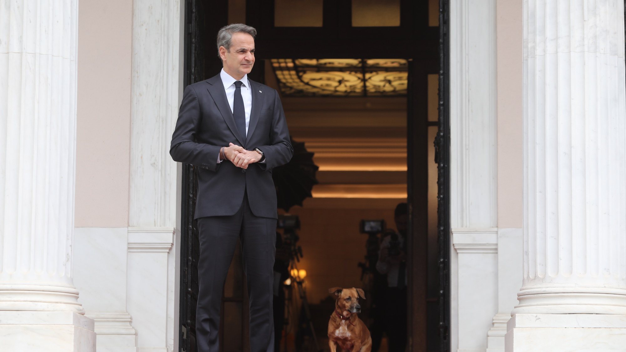 epa10520136 Greek Prime Minister Kyriakos Mitsotakis and his dog Peanut, wait to welcome the President of Cyprus in Maximos Mansion, Athens, Greece, 13 March 2023. Newly elected President of the Republic of Cyprus Nikos Christodoulides is paying his first official visit to Athens between 12 and 14 March.  EPA/GEORGE VITSARAS