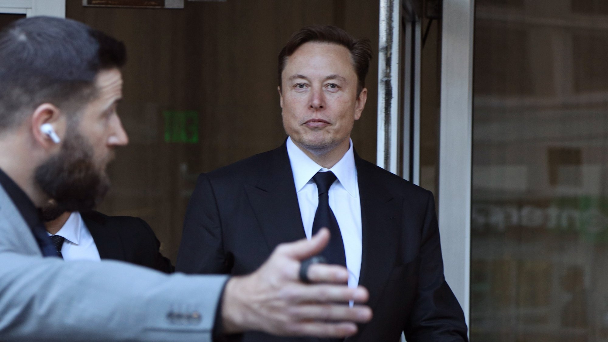 epa10427344 Tesla CEO Elon Musk leaves the Phillip Burton Federal Building and US Courthouse for the fourth day of the trial of Tesla shareholders lawsuit against Musk in San Francisco, California, USA, 24 January 2023. Tesla shareholders against CEO Elon Musk are taking him to court after he tweeted in 2018 that he could take Tesla private at 240 US dollars a share, a statement that caused volatility in the electric car company&#039;s stock price.  EPA/GEORGE NIKITIN