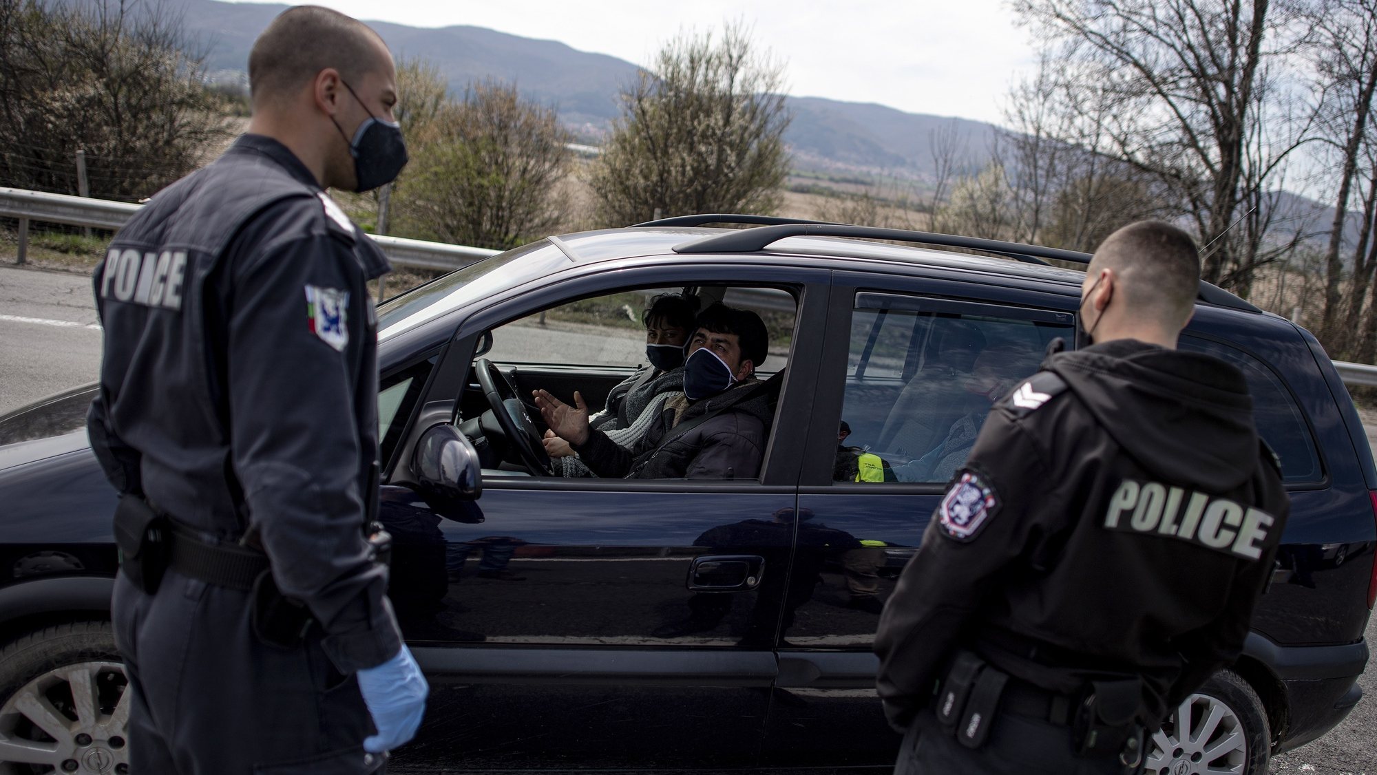 epa08368788 Bulgarian police officers check the documents of motorists at a check point on the highway Hemus in Sofia, Bulgaria, 17 April 2020, during the coronavirus disease (COVID-19) pandemic. Bulgarian authorities banned all traffic in and out of the capital Sofia from 17 April until further notice as the country tightened measures to counter the spread of the COVID-19 infectious disease. The measure coincides with a four-day weekend, when Bulgaria celebrates the Orthodox Easter on 19 April. The travel ban envisages all type of cars and intercity buses, except for vehicles for cargo purposes, vehicles with people travelling for medical treatment, emergency crews of electric and water companies, internet and TV service providers.  EPA/VASSIL DONEV
