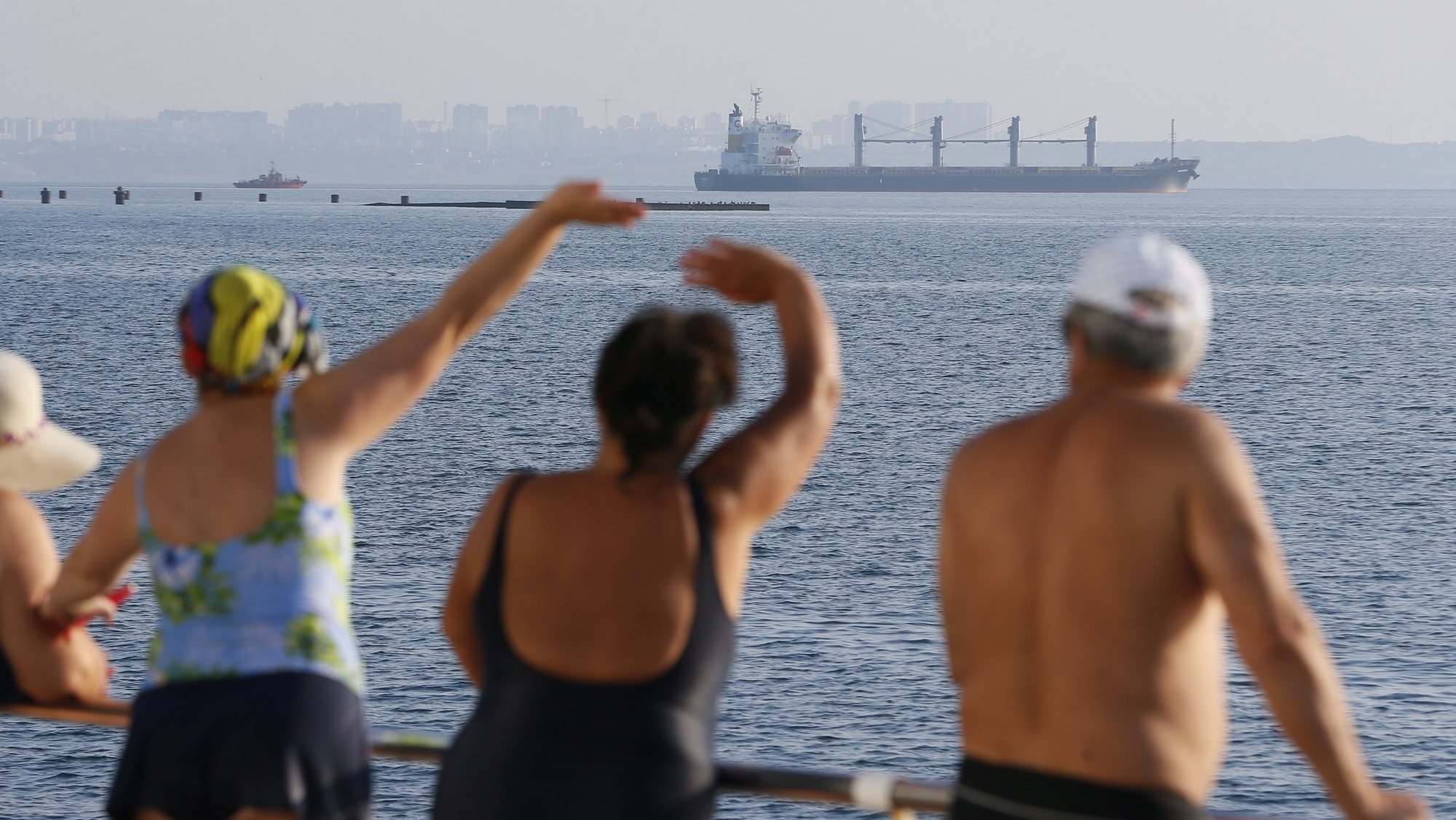 epaselect epa10106874 People watch cargo vessel Navi Star carrying 33,000 tonnes of corn to Ireland leave the port of Odesa, Ukraine, 05 August 2022. Two vessels left the port of Chornomorsk and one from the Odesa port. The bulk carriers NAVI STAR, ROJEN, and POLARNET with a total of 57,000 tonnes of corn on board are headed for Turkey, Great Britain, and Ireland as the Administration of Seaports of Ukraine reported. Ukraine started exporting grain since a safe passage deal was signed between Ukraine and Russia on 22 July in Istanbul. Russian troops on 24 February entered Ukrainian territory, starting a conflict that has provoked destruction and a humanitarian crisis.  EPA/STR