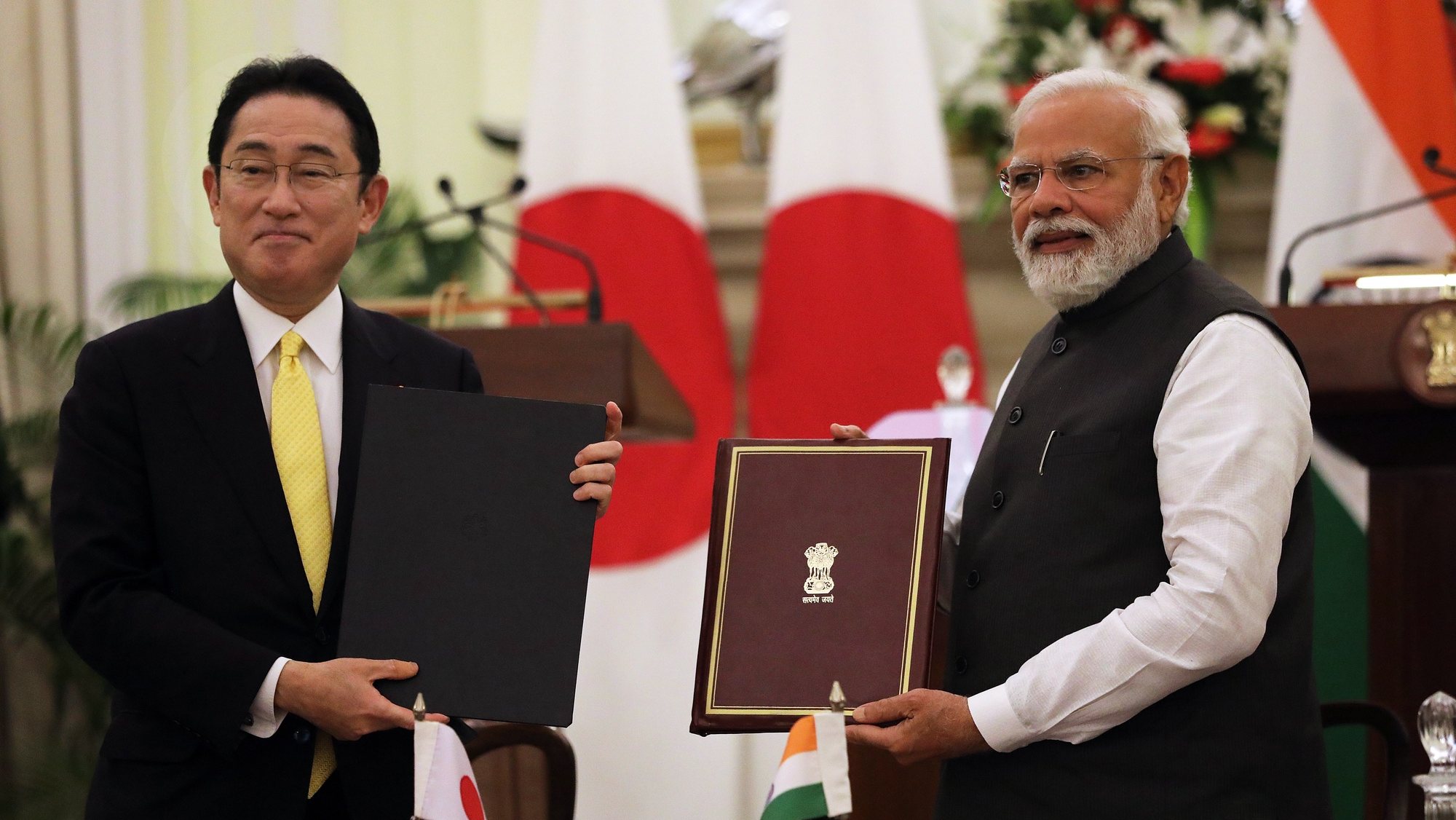 epa09836215 Indian Prime Minister Narendra Modi (R ) and Japanese Prime Minister Fumio Kishida exchange documents after signing the joint statement  in New Delhi, India, 19 March 2022. Prime Minister Fumio Kishida is on a two-day visit to India where he will attend the 14th India-Japan summit. Kishido announced 42 billion US dollar investment target in India over the next five years. India and Japan signed the series of agreements including the cyber security.  EPA/HARISH TYAGI